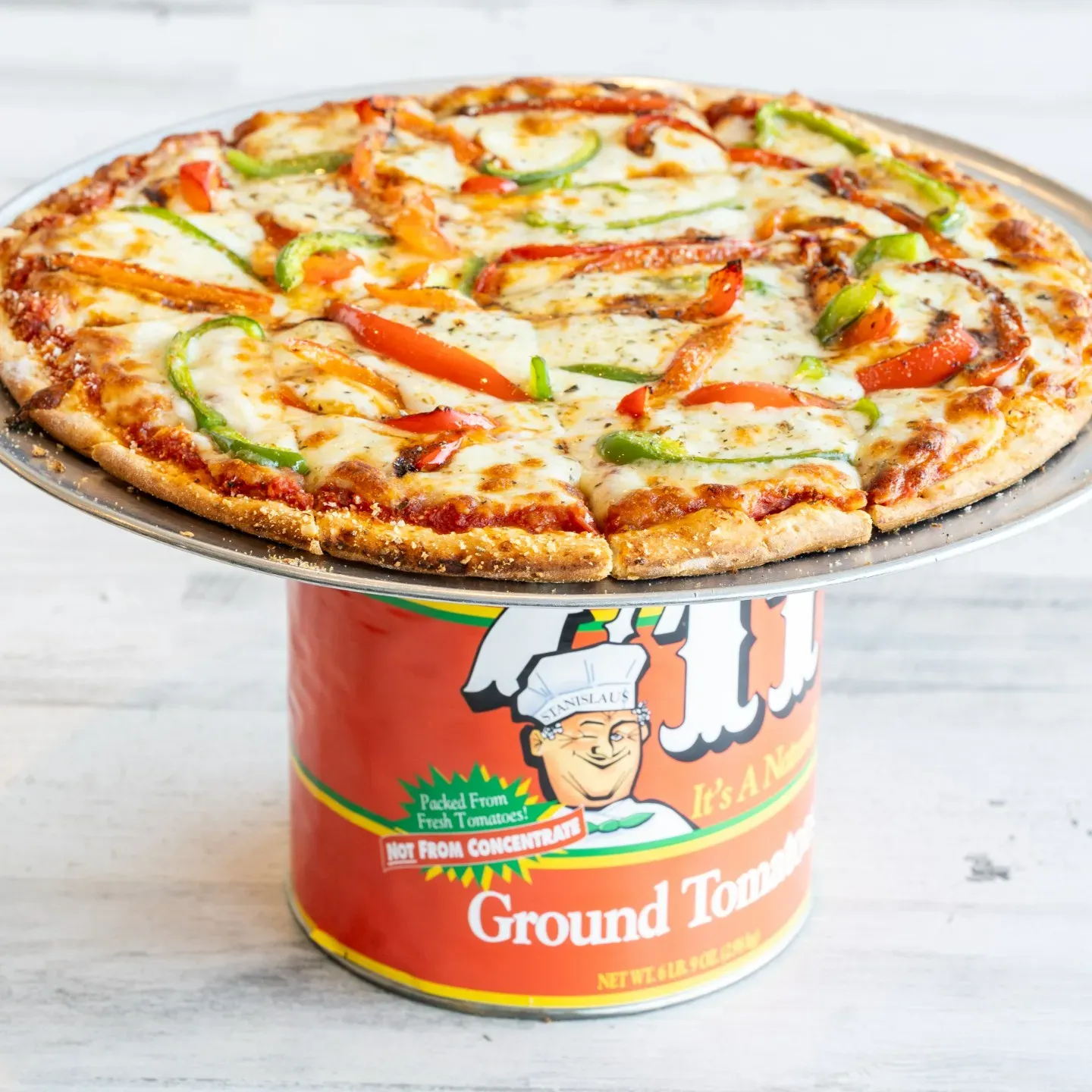A pizza in a can with a man on the front.