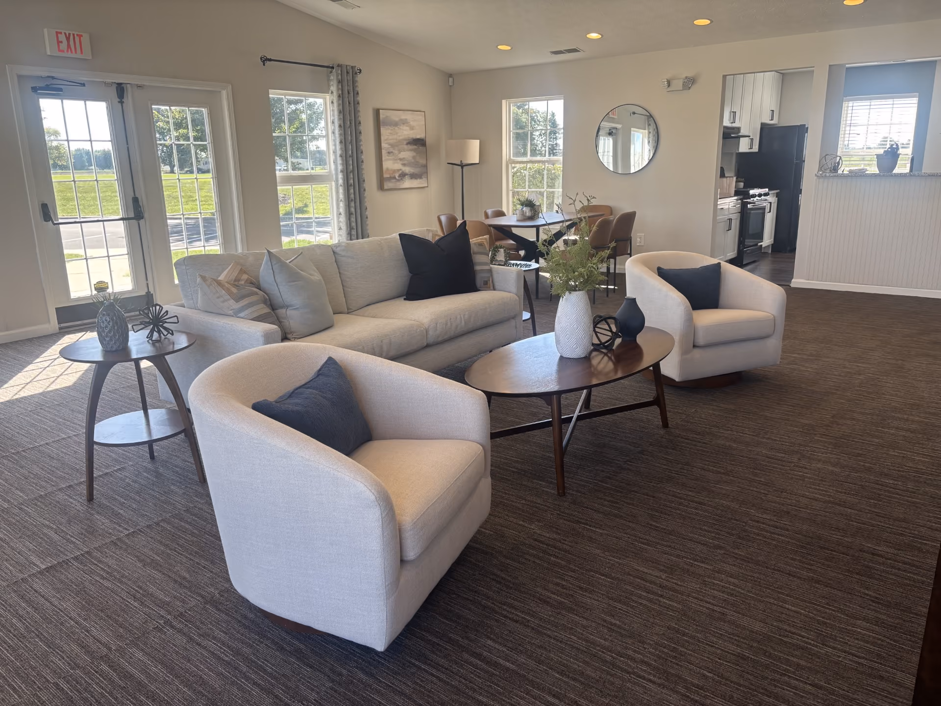 clubhouse lounge area with sofas and view of kitchen