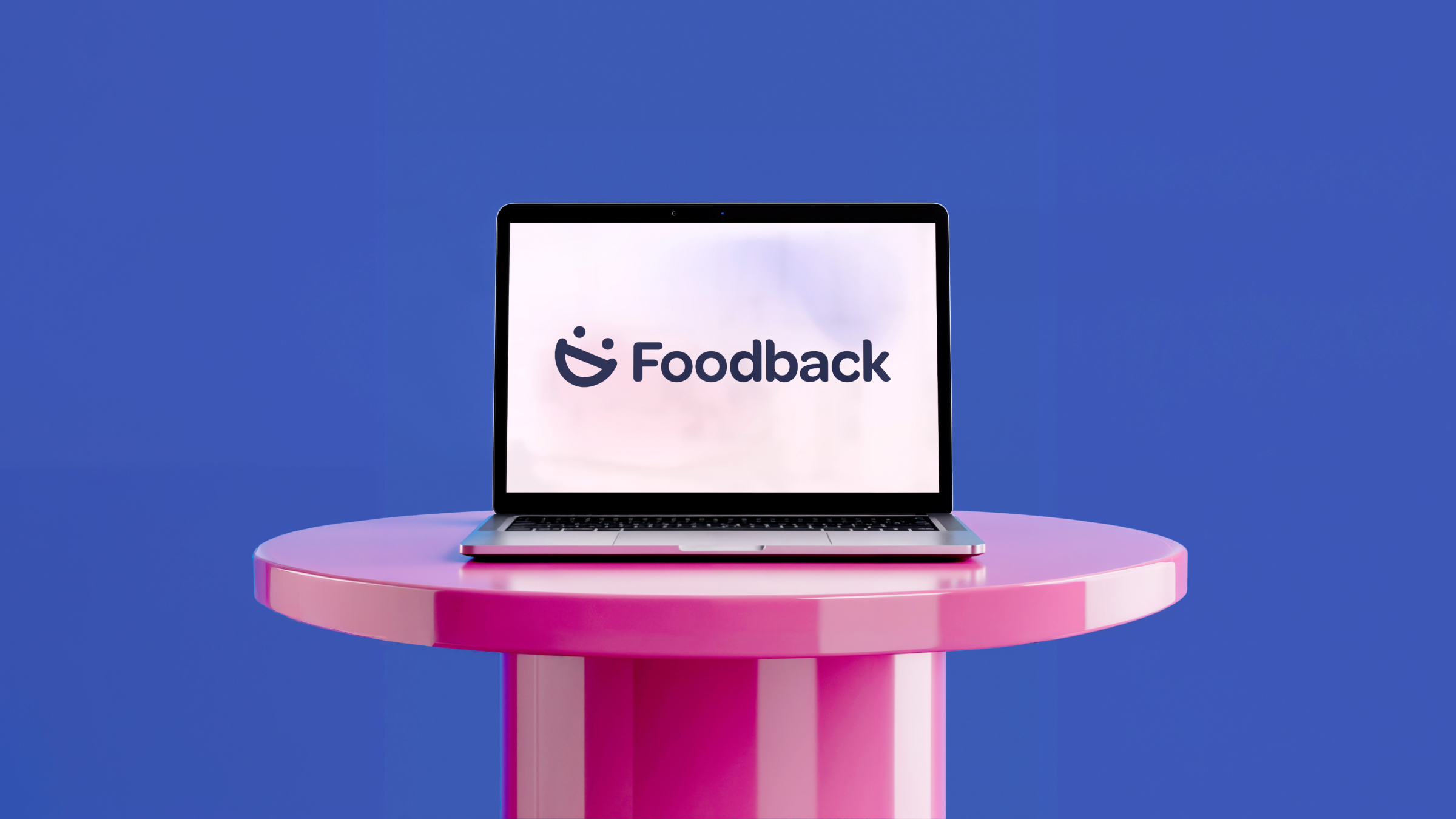 A laptop showing the Foodback logo on a pink pedestal against a bright blue background