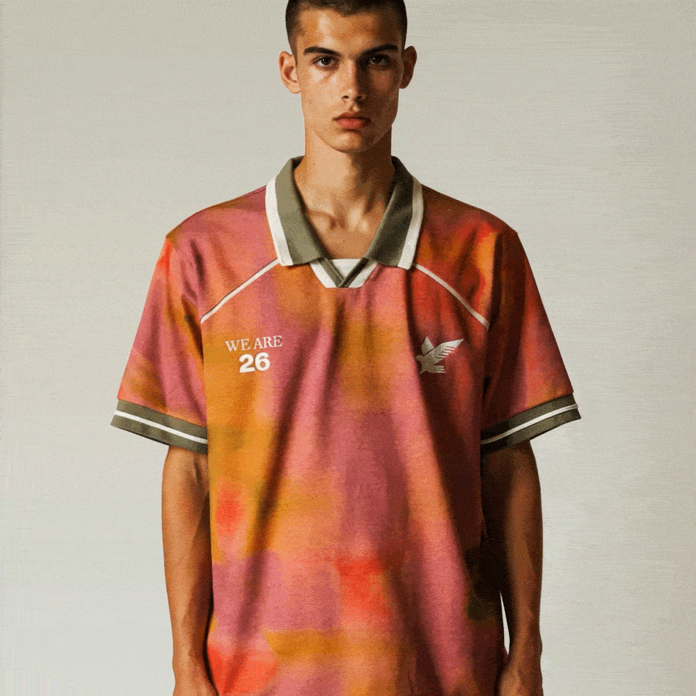 Man walking out of frame wearing a jersey