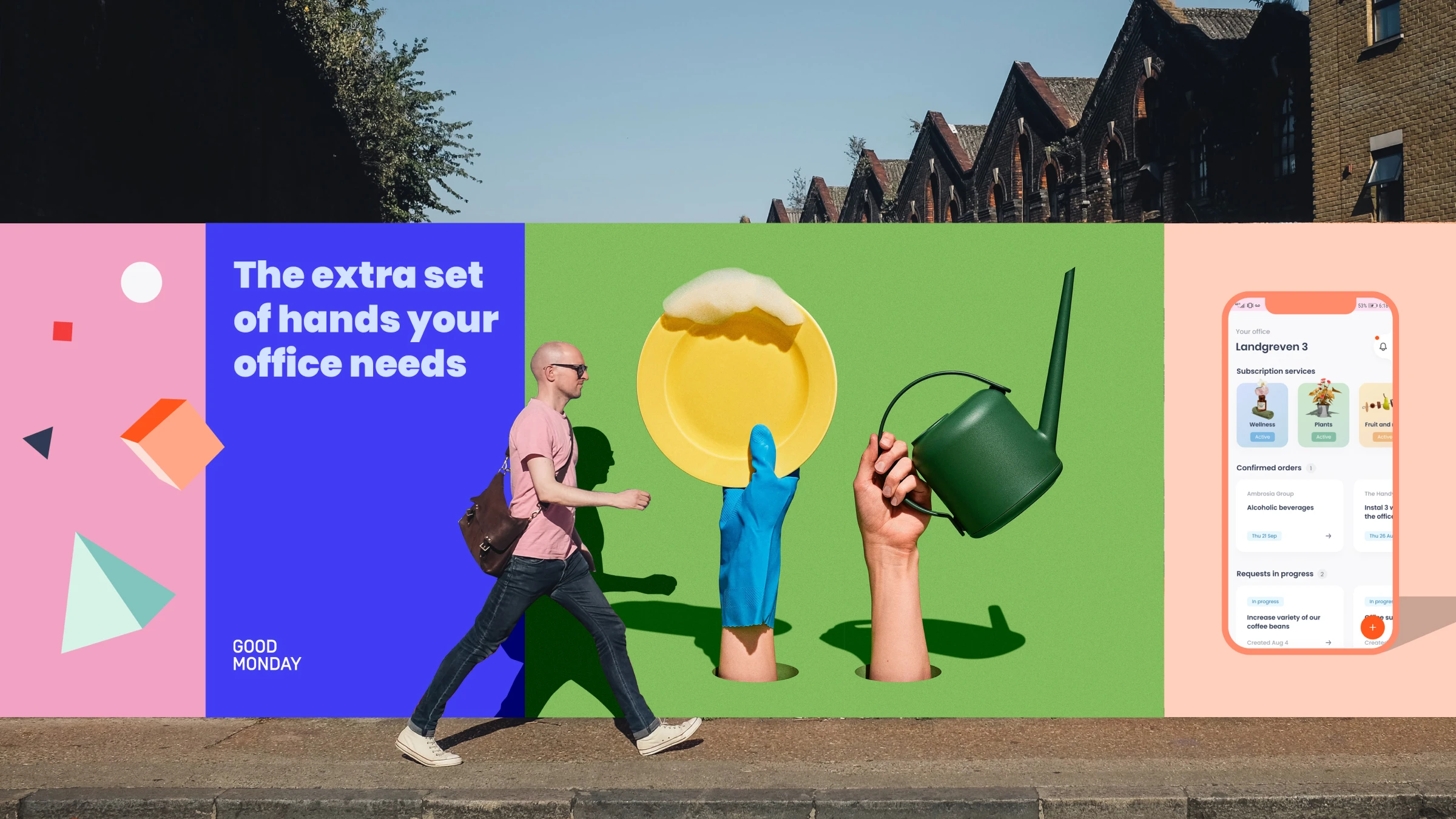 A wide horizontal billboard divided into sections for Good Monday is displayed on a street in front of brick buildings