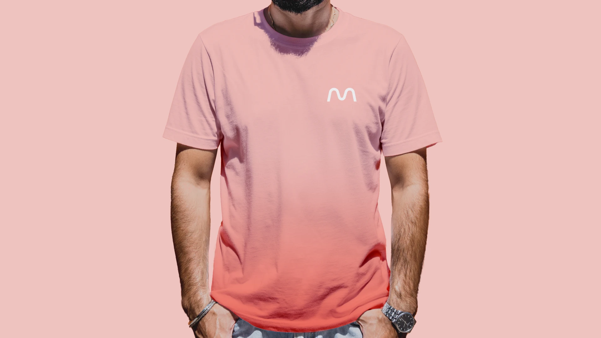 A man wearing a Humani gradient pink shirt