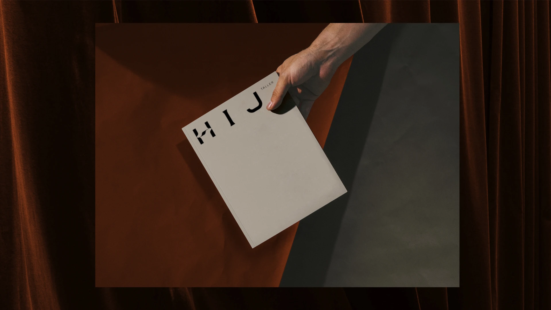 Close up hand holding an HIJ publication