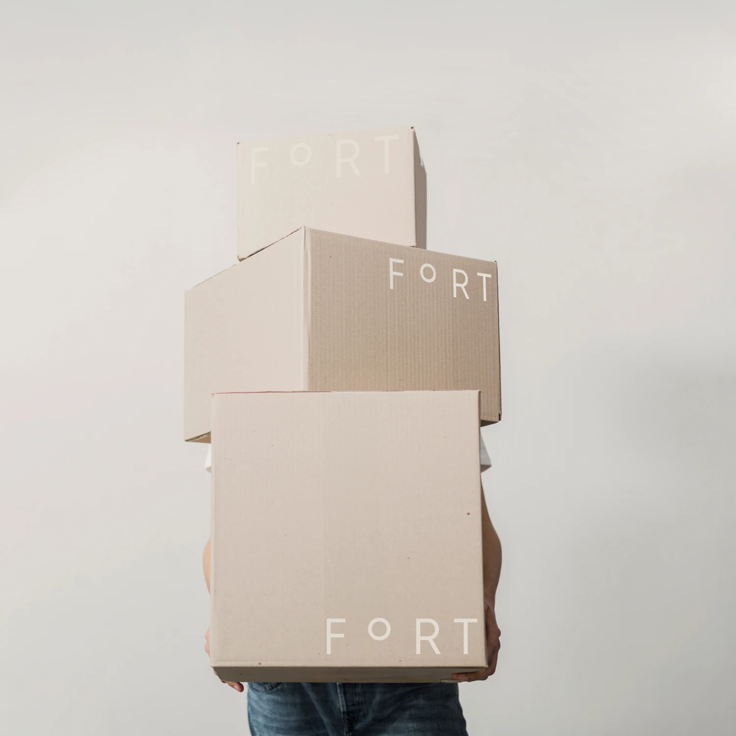 Person carrying three Fort boxes