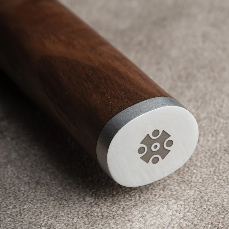 knife handle with a carved symbol