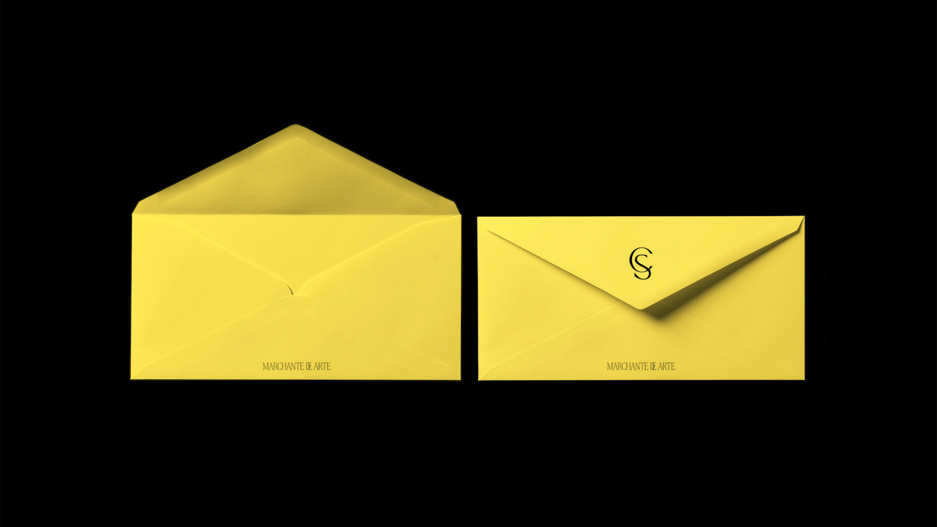 Stationery design for Casa Salazar showing envelopes with a vibrant yellow and black color palette.