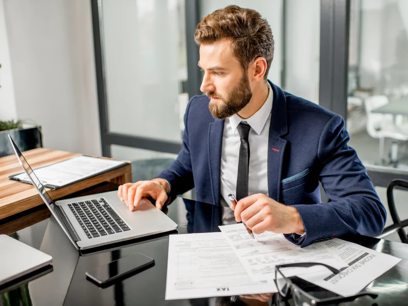 Professional organizing tasks and priorities at a desk in a modern workplace.