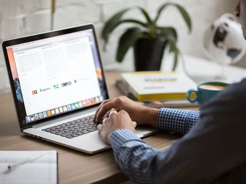 Professional reviewing emails on a computer to organize daily work priorities.