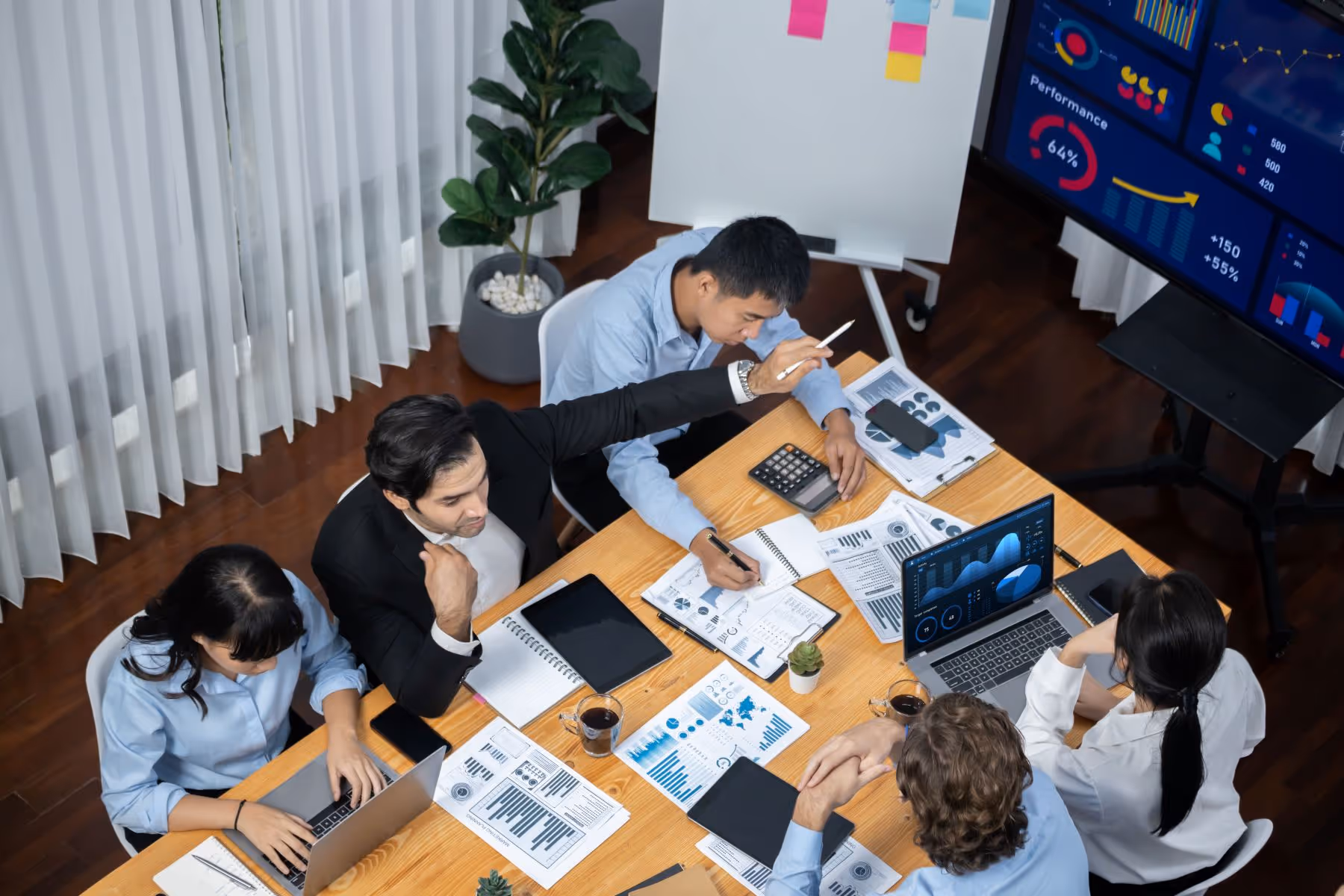 A large desk with diverse team working together 