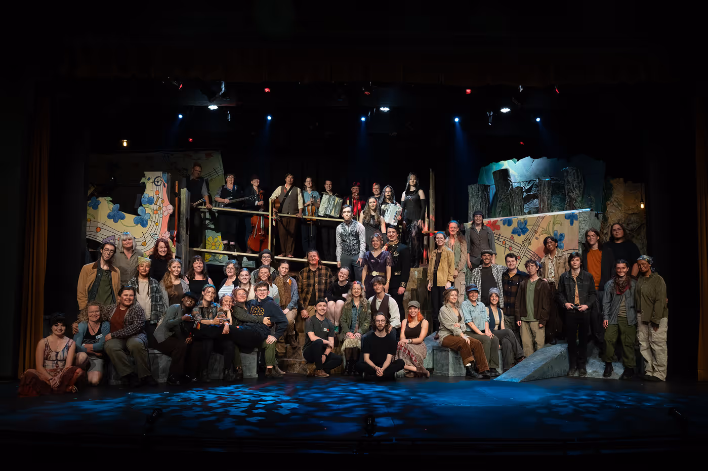 The full cast stands together onstage for a curtain call at the end of the dress rehearsal for Hadestown: Teen Edition.