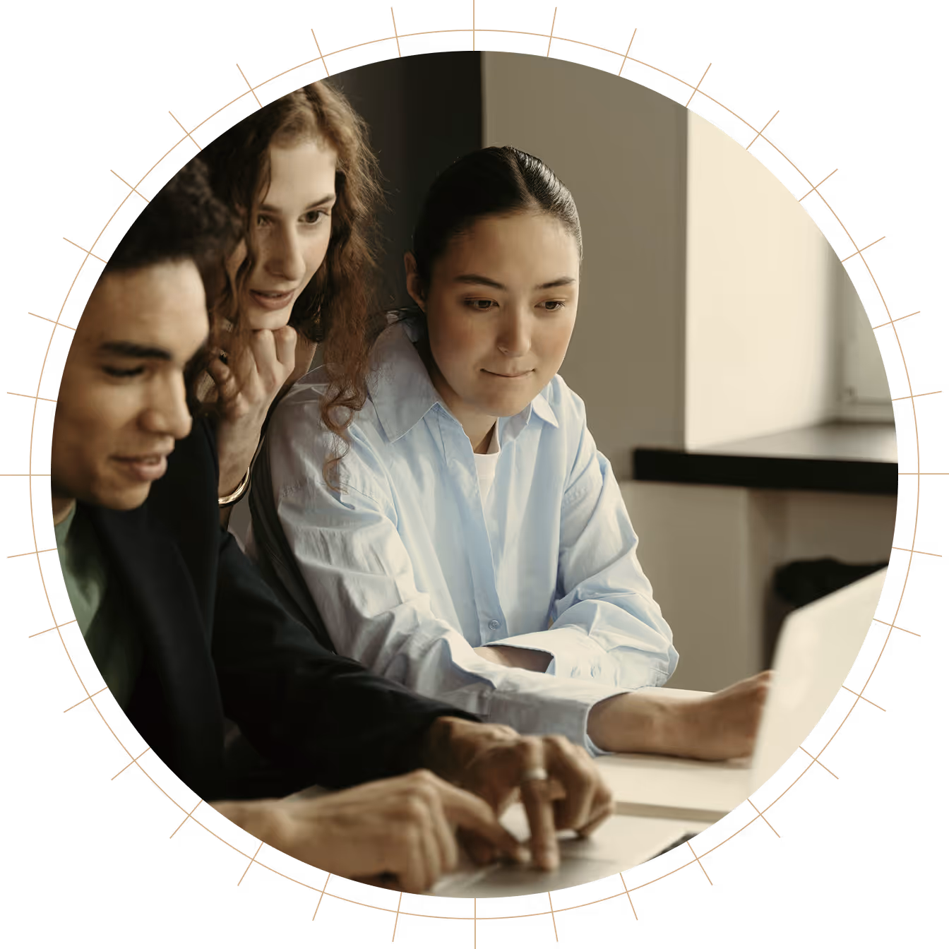 Three young adults gathered around a laptop, focused on the screen and collaborating.