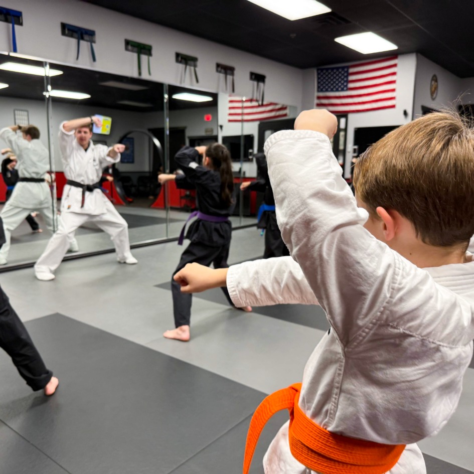 A kid karate student at USSD Oceanside participates in a disciplined group Class.