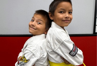 Young, Orange Belt Karate Student with his hands ready.