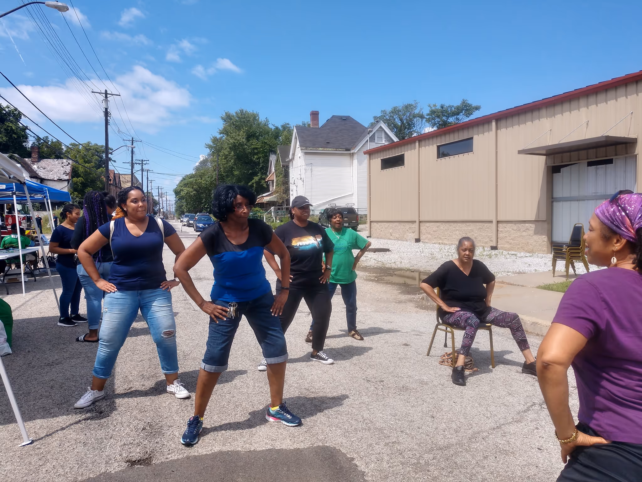 Myrna leading an outdoor workout during an event.