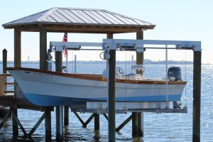 A small fishing boat stored on a boat lift.