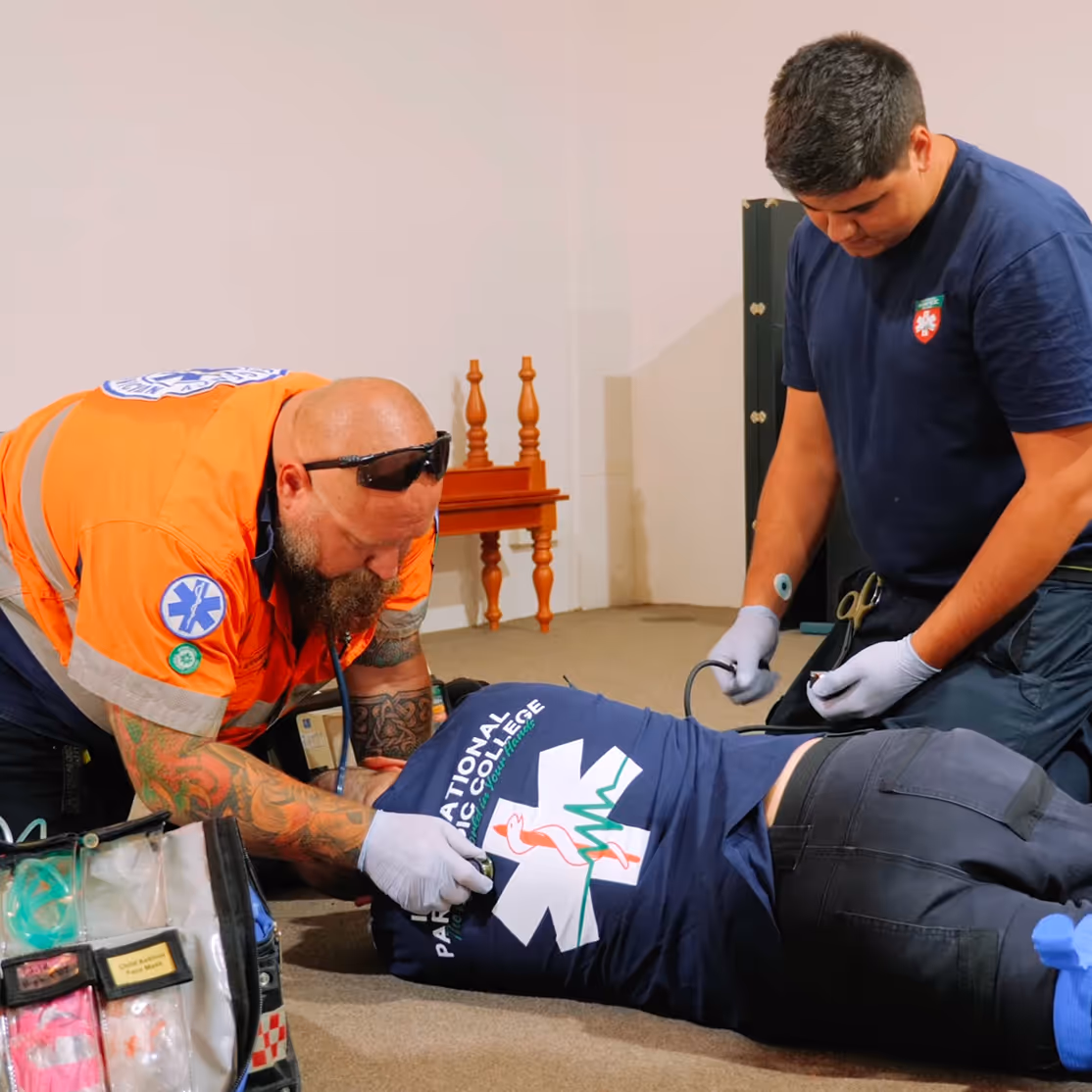 Paramedic training session with students practicing emergency response techniques