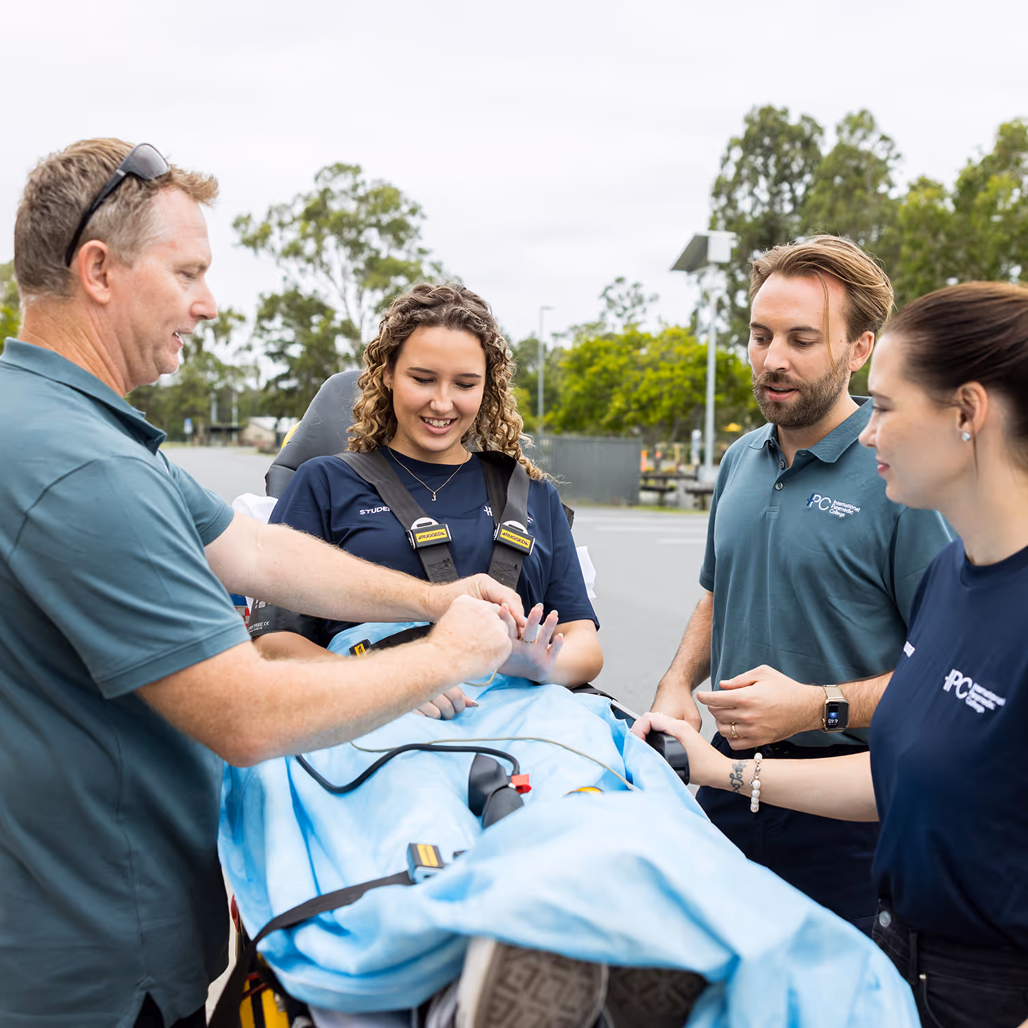 IPC instructors guiding students through emergency medical techniques in the training facility