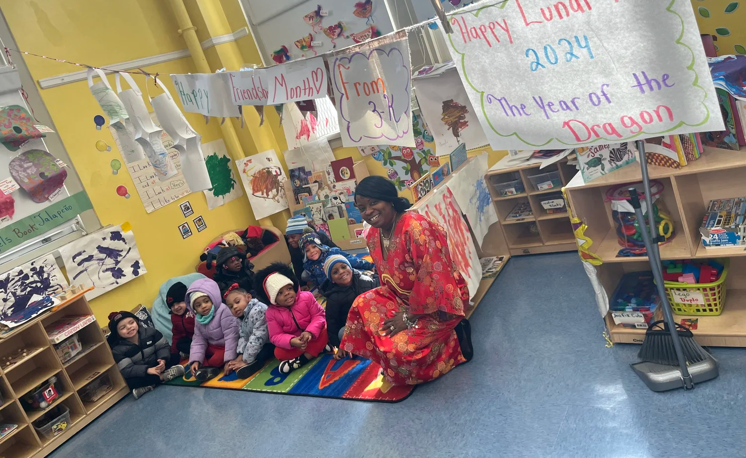 Five children smiling and standing in a gymnasium