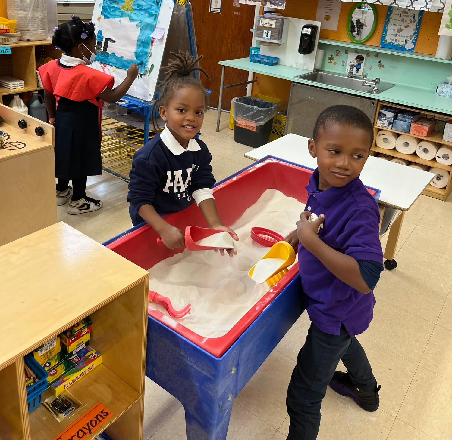 Three children in a classroom