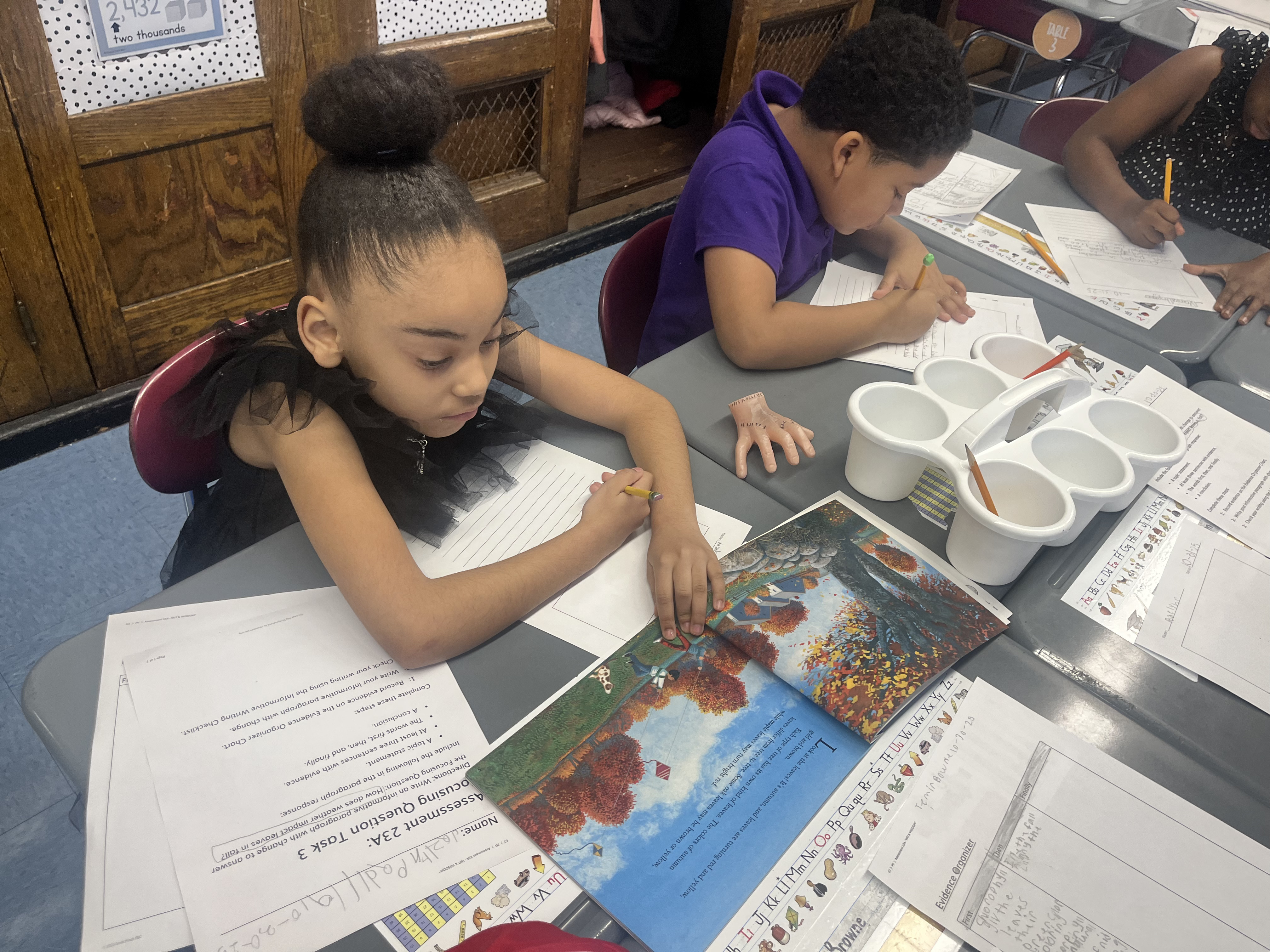 Five children standing on a polished gym floor 