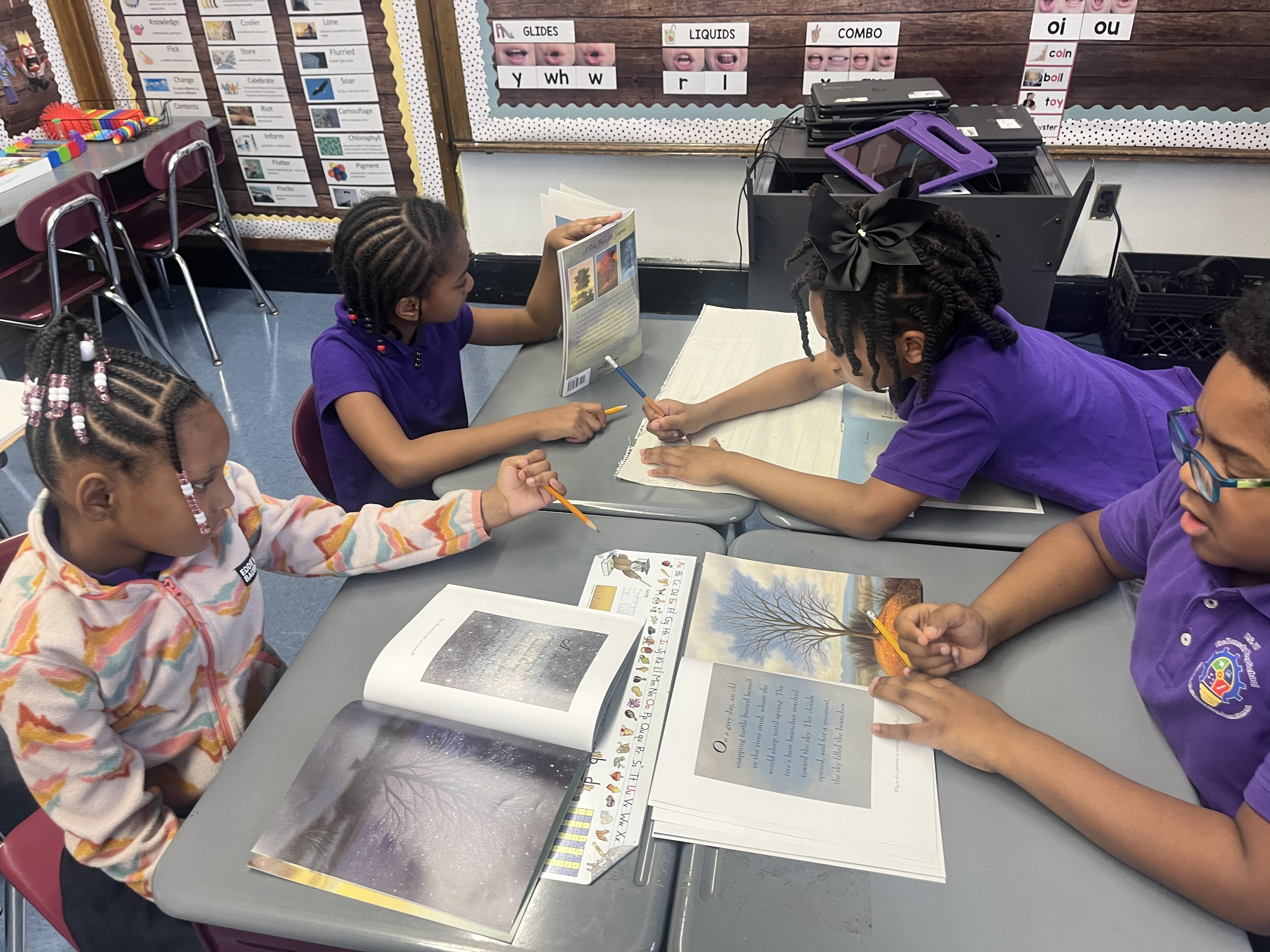 Five children standing on a polished gym floor 