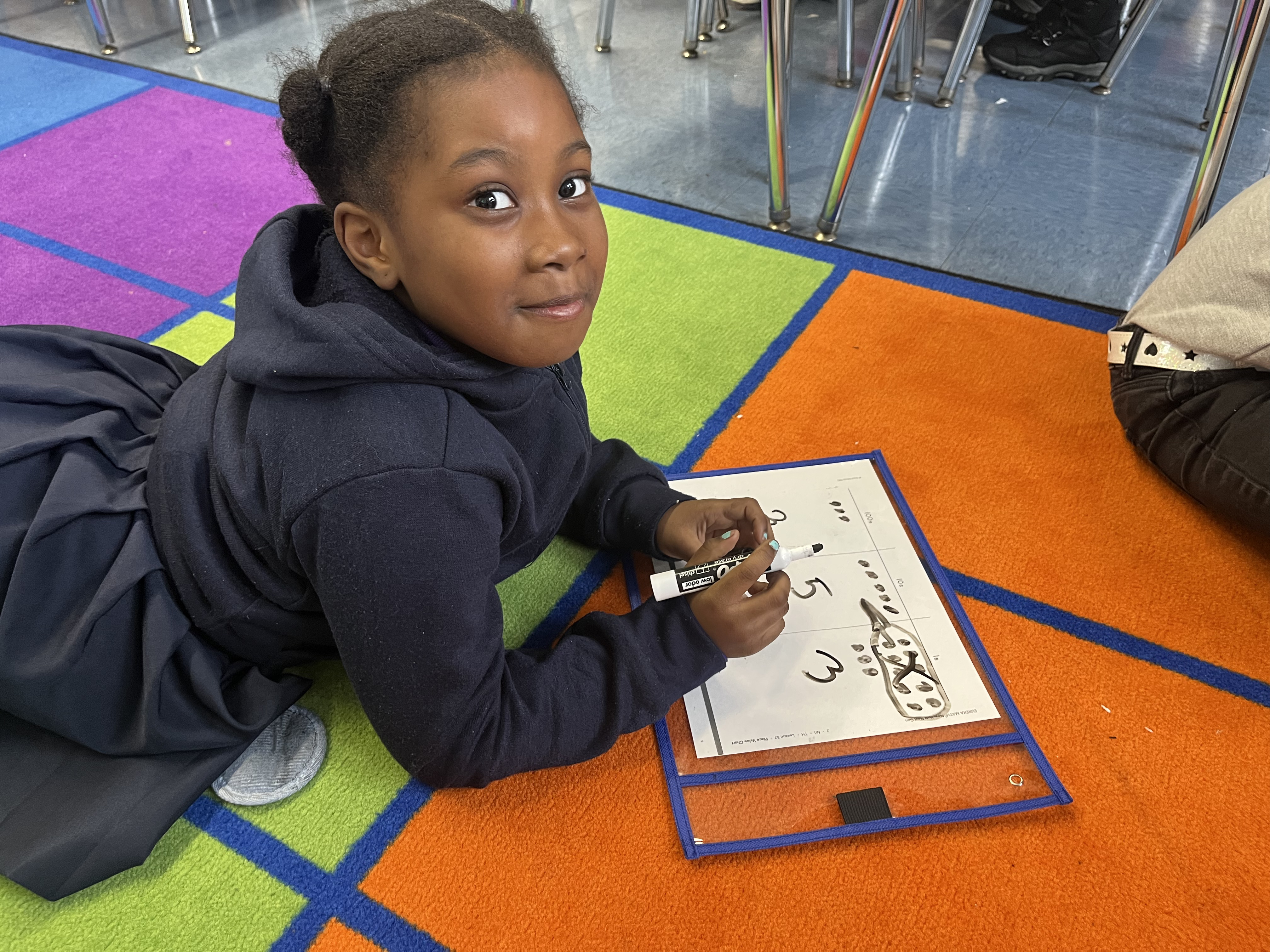 Five children standing on a polished gym floor 