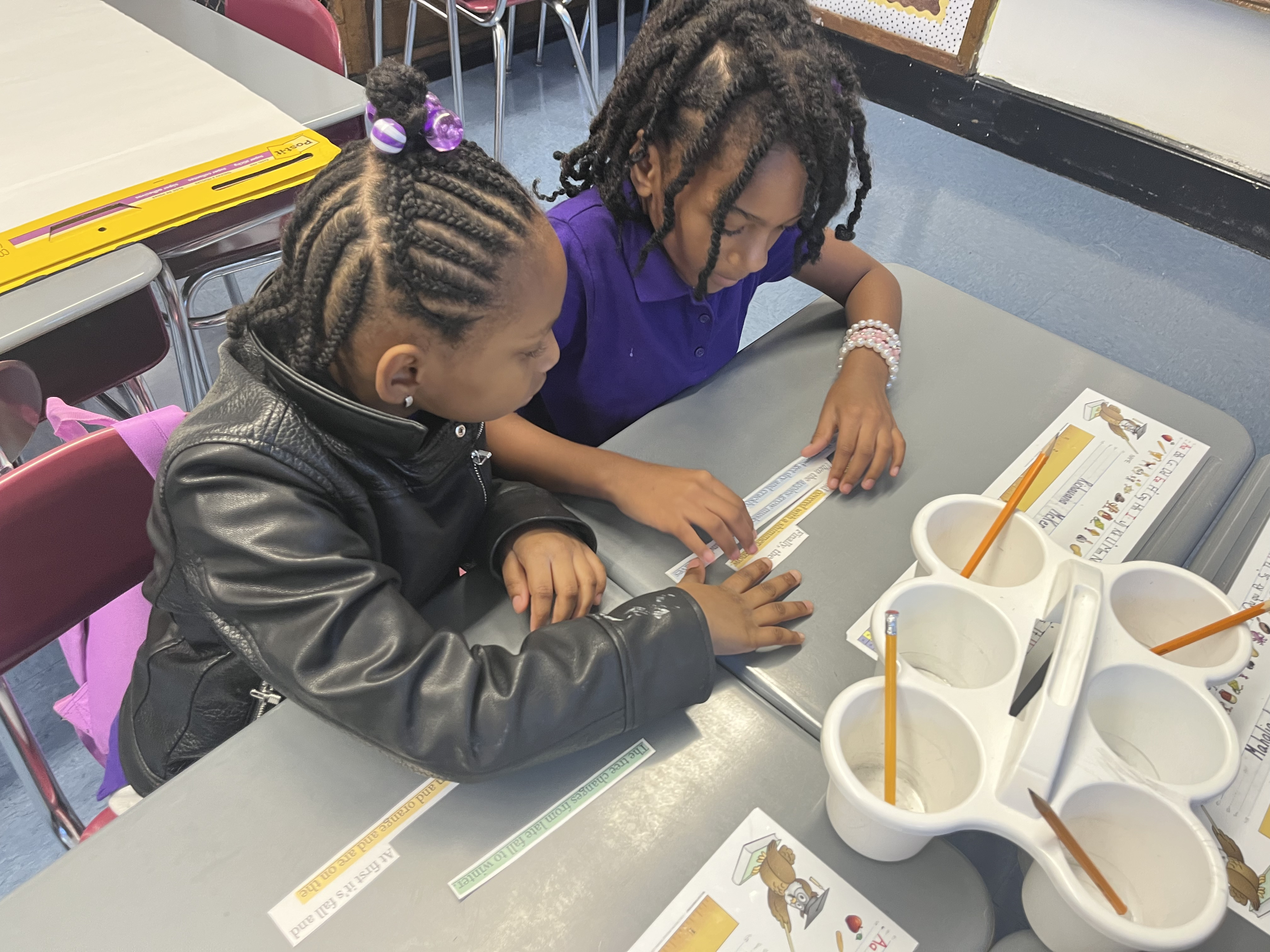 Five children standing on a polished gym floor 