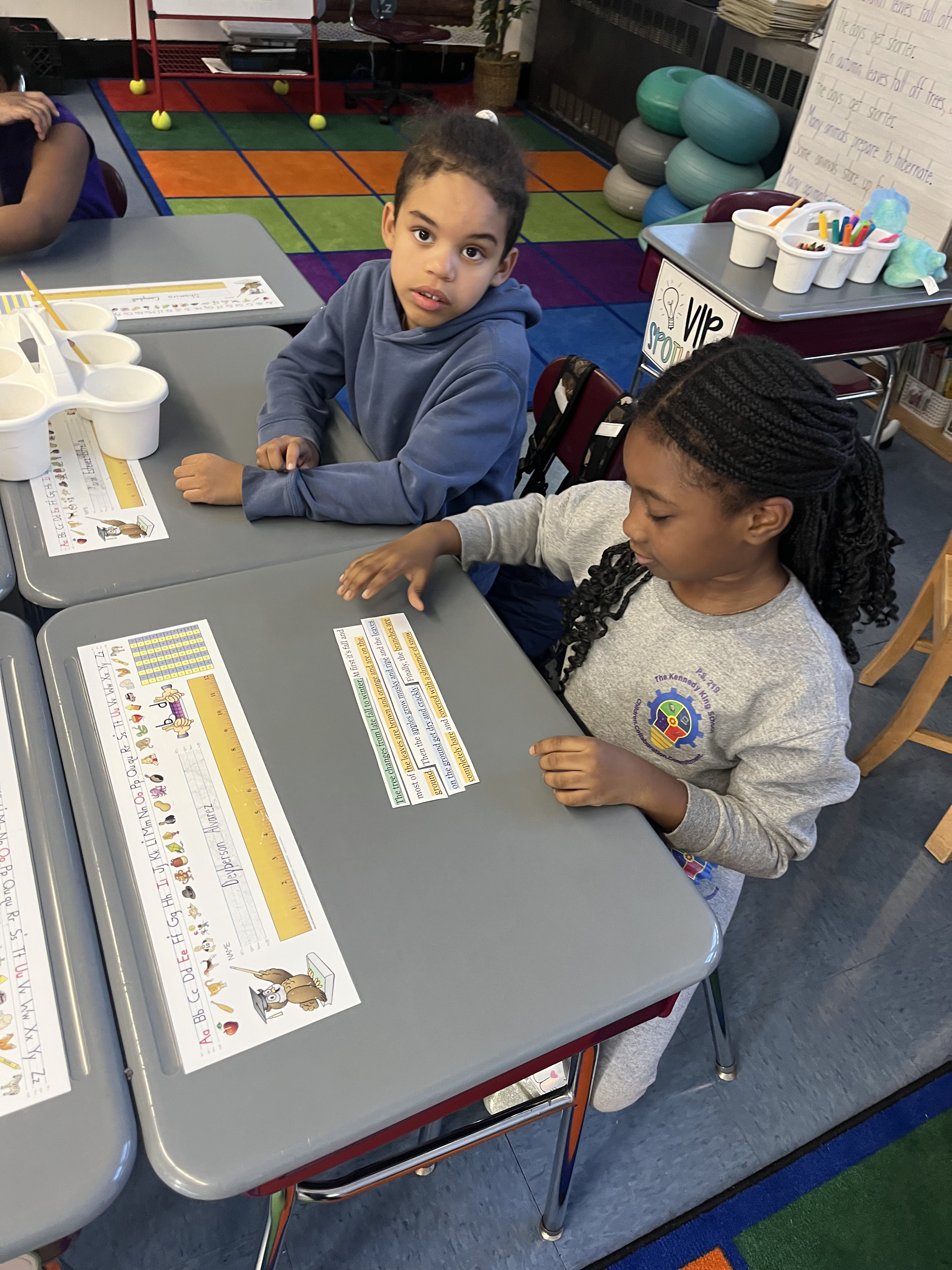 Five children standing on a polished gym floor 
