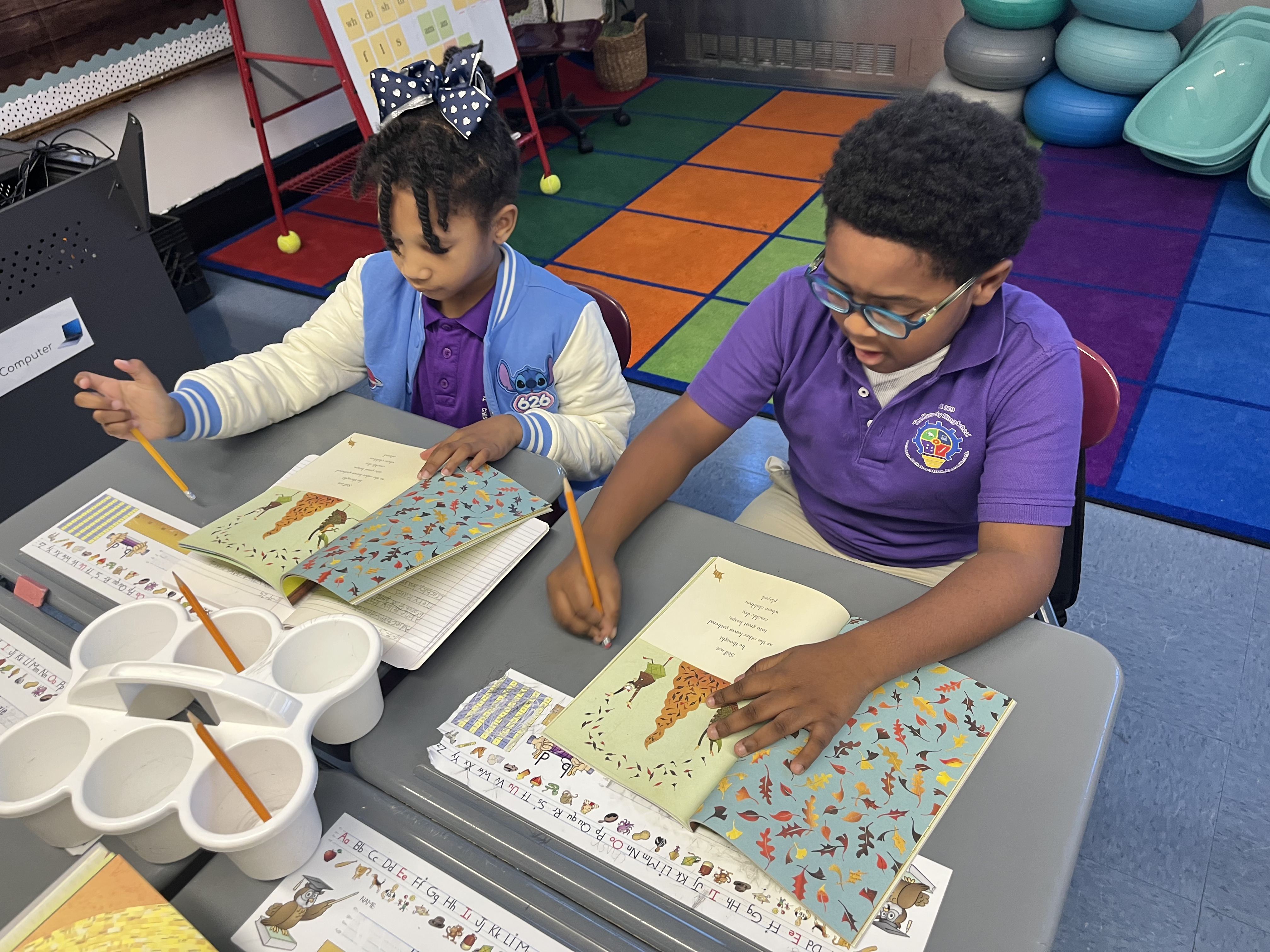 Five children standing on a polished gym floor 