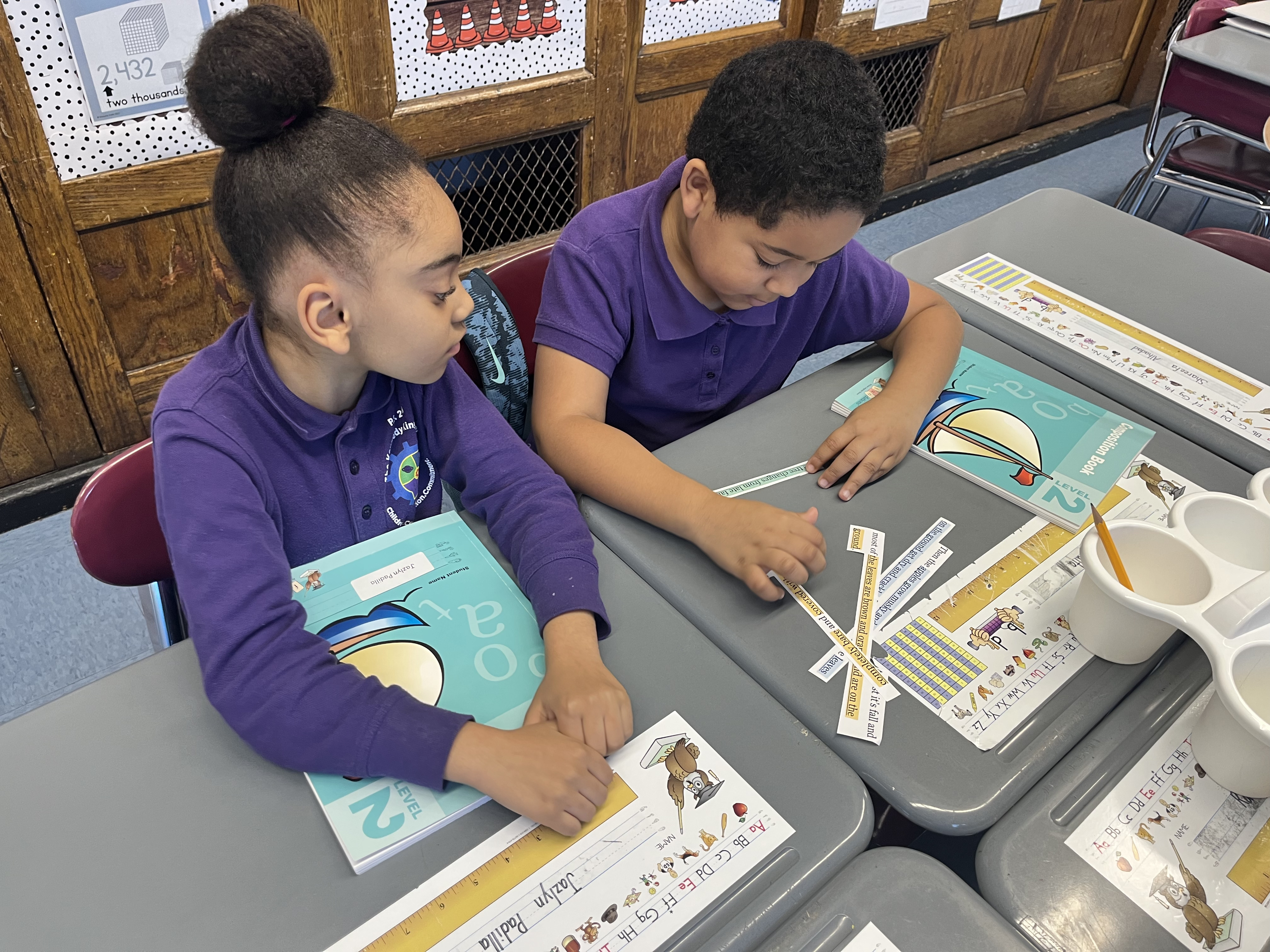Five children standing on a polished gym floor 