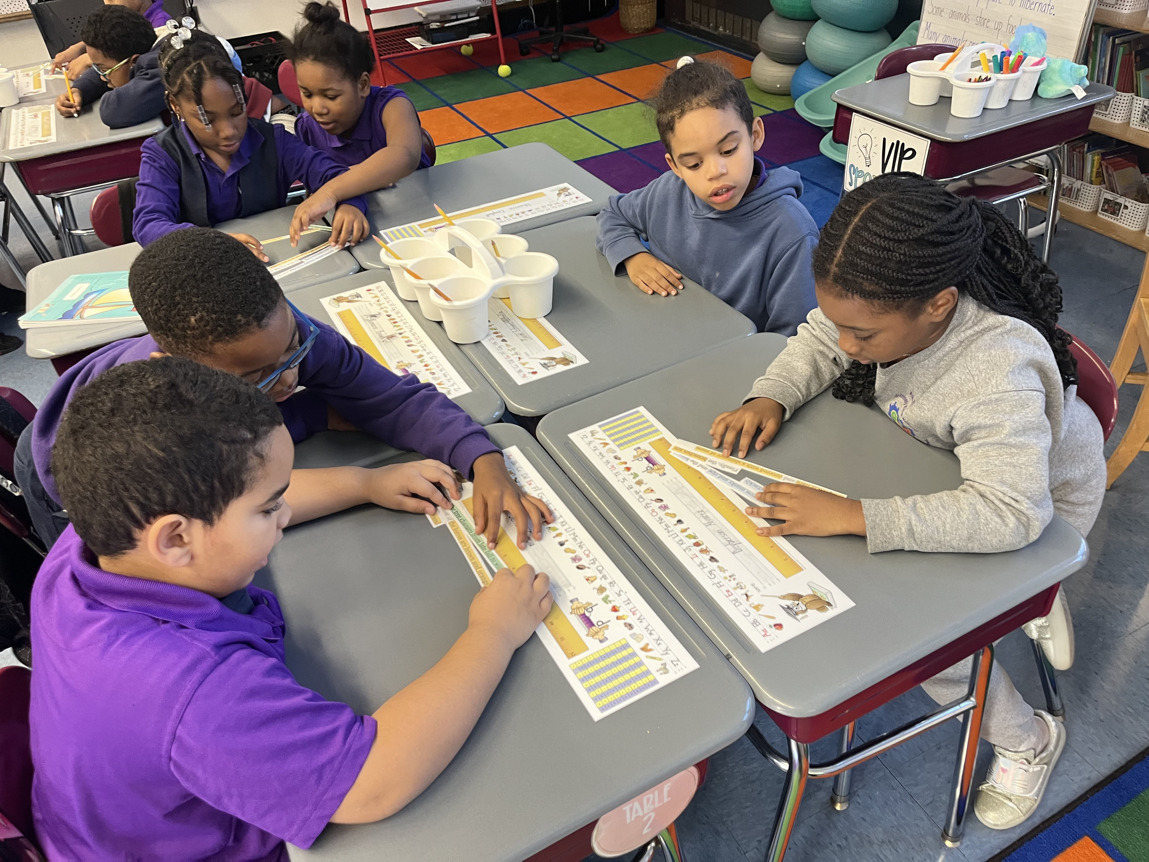 Five children standing on a polished gym floor 