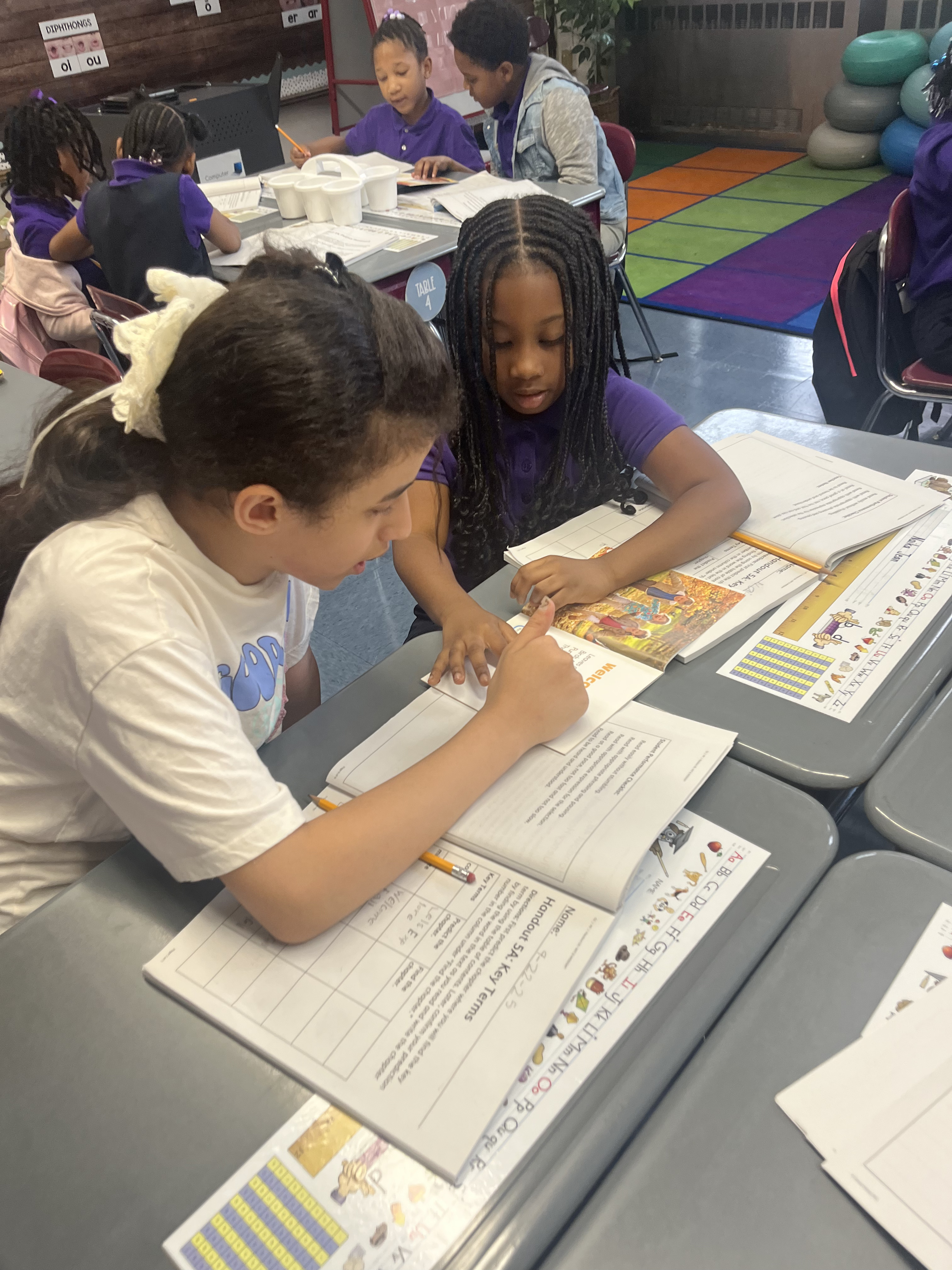 Five children standing on a polished gym floor 