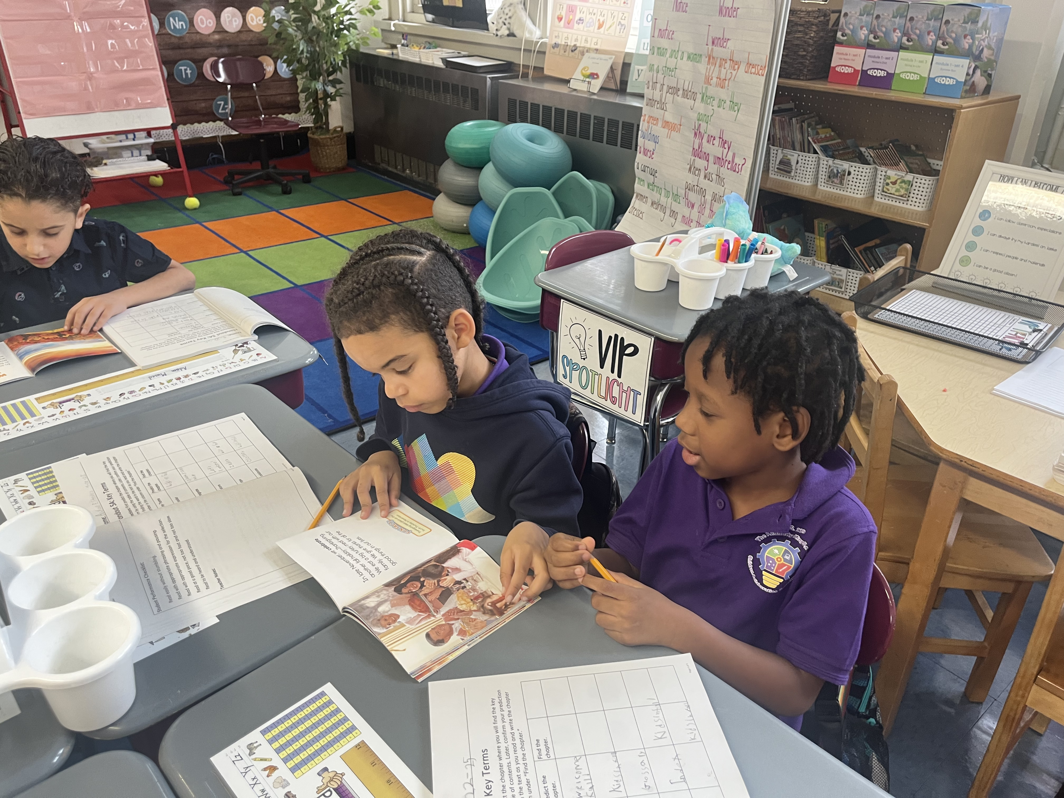 Five children standing on a polished gym floor 