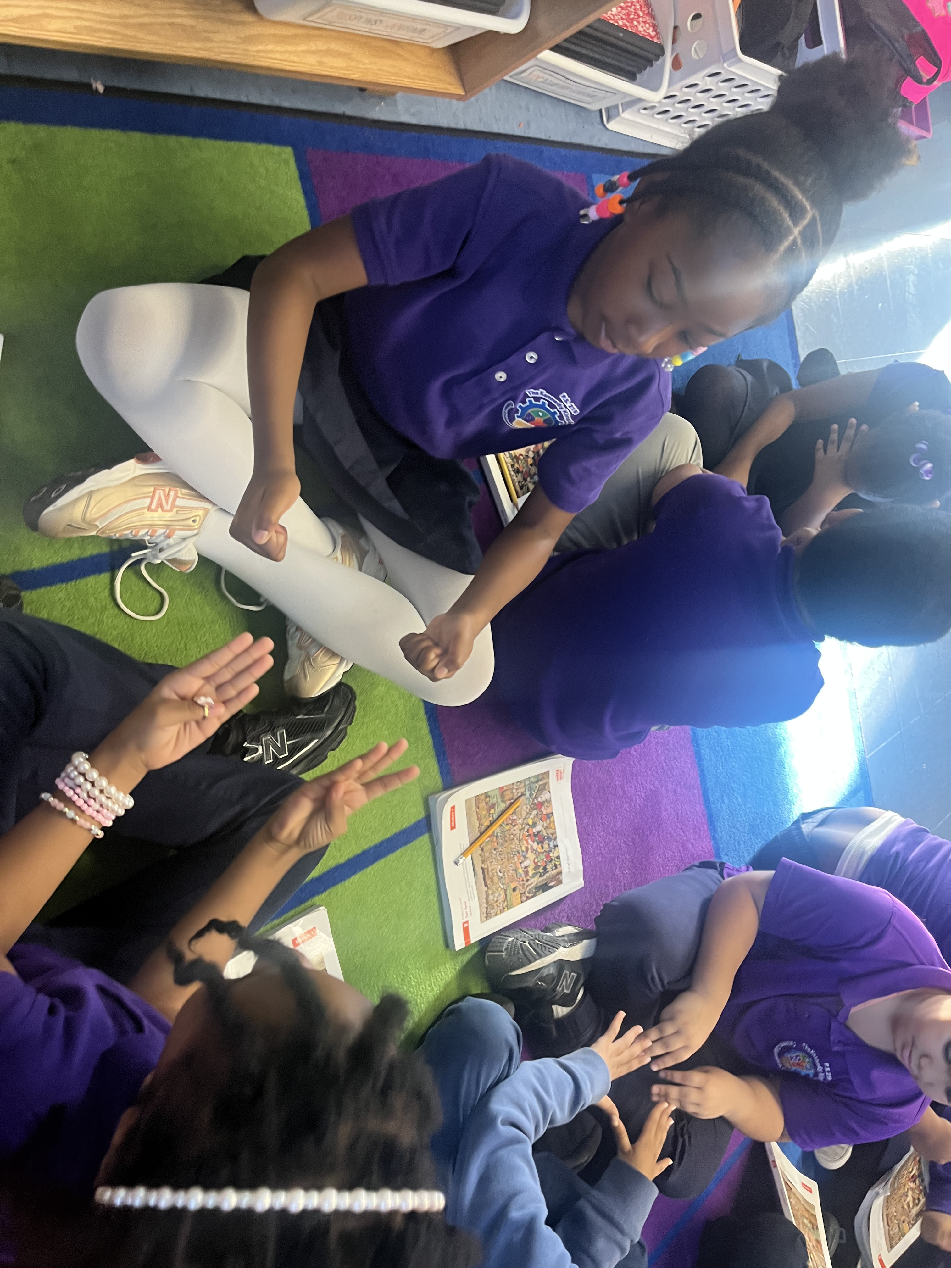 Five children standing on a polished gym floor 