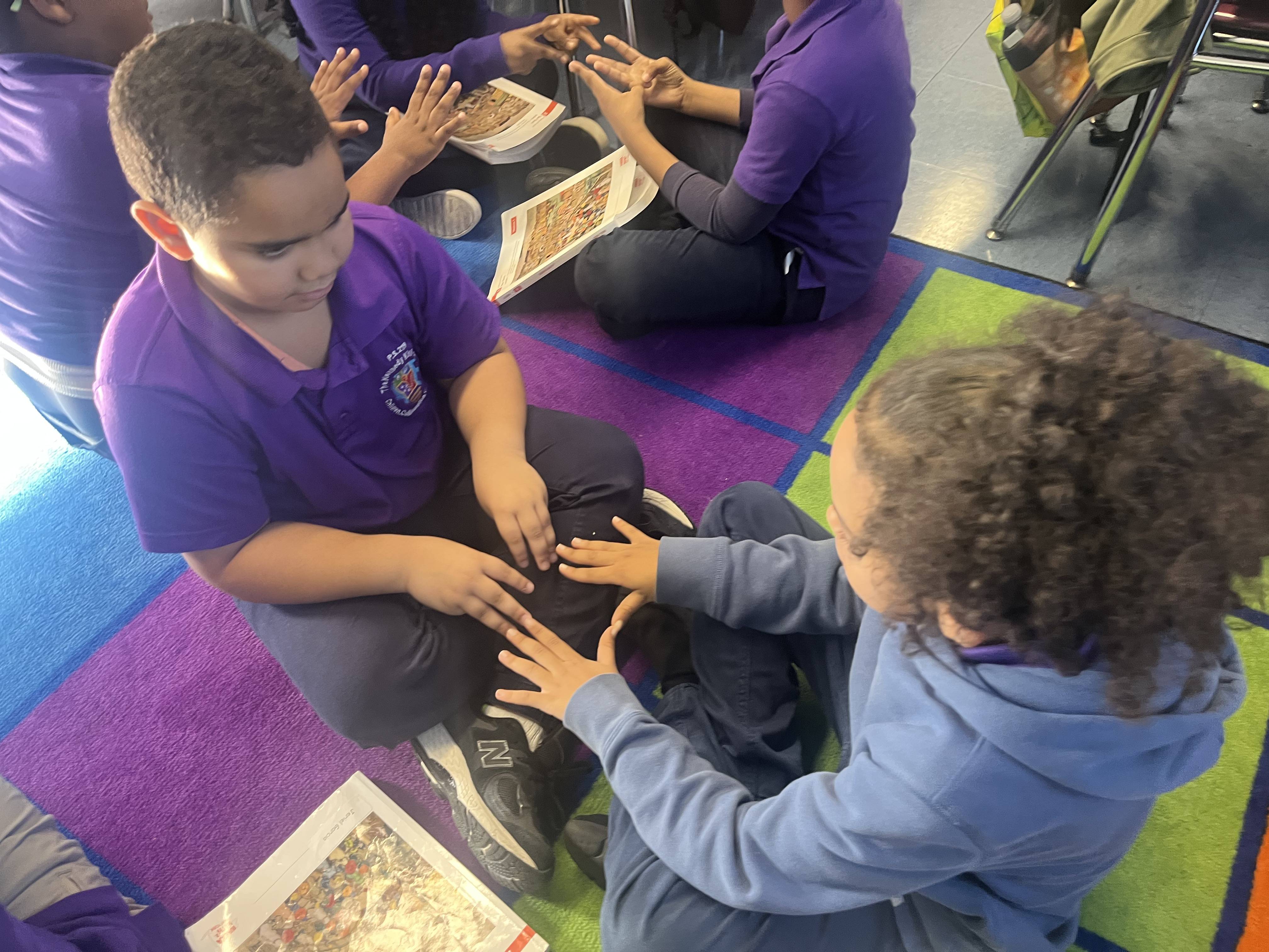 Five children standing on a polished gym floor 