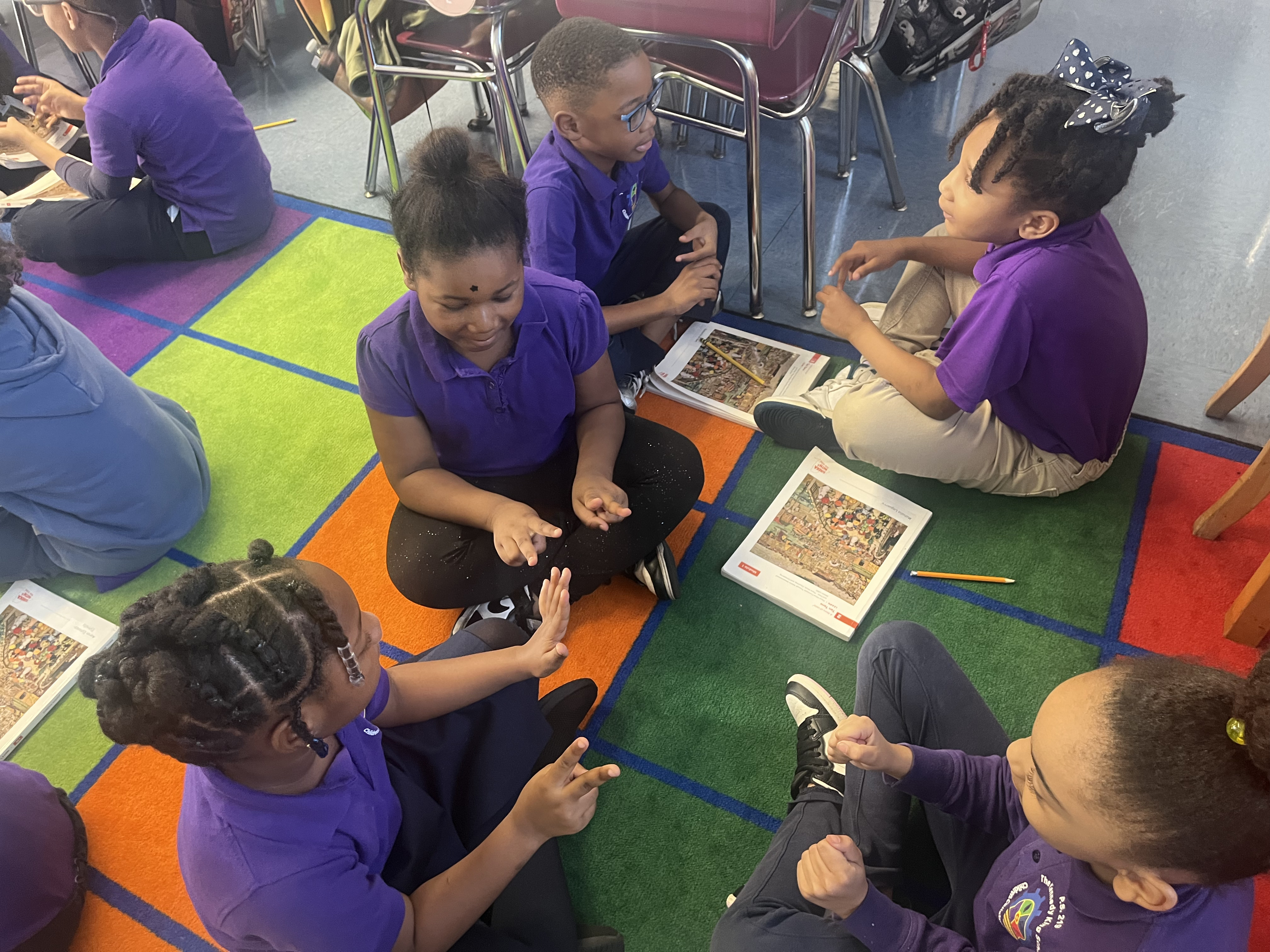 Five children standing on a polished gym floor 