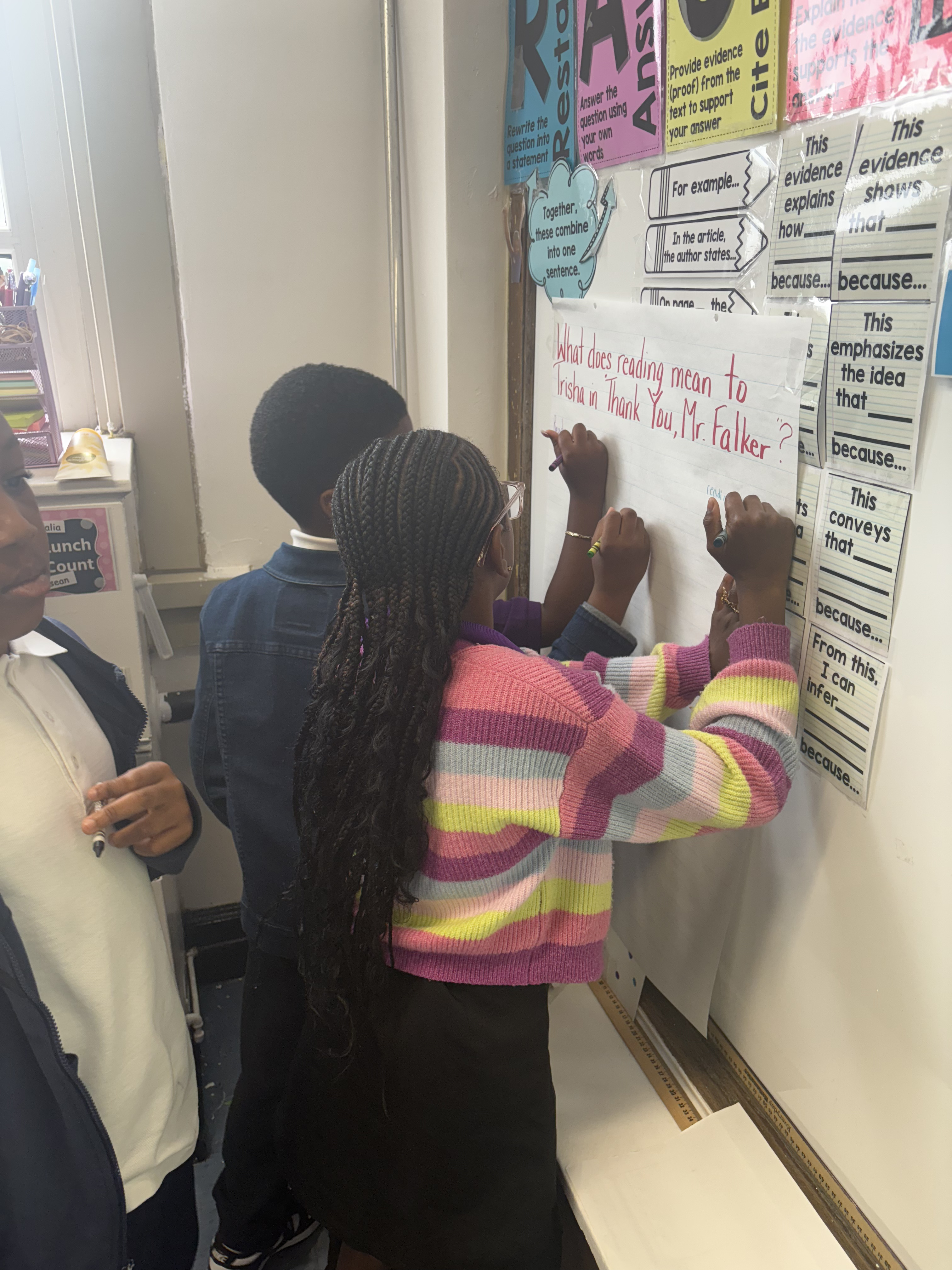 Five children standing on a polished gym floor 