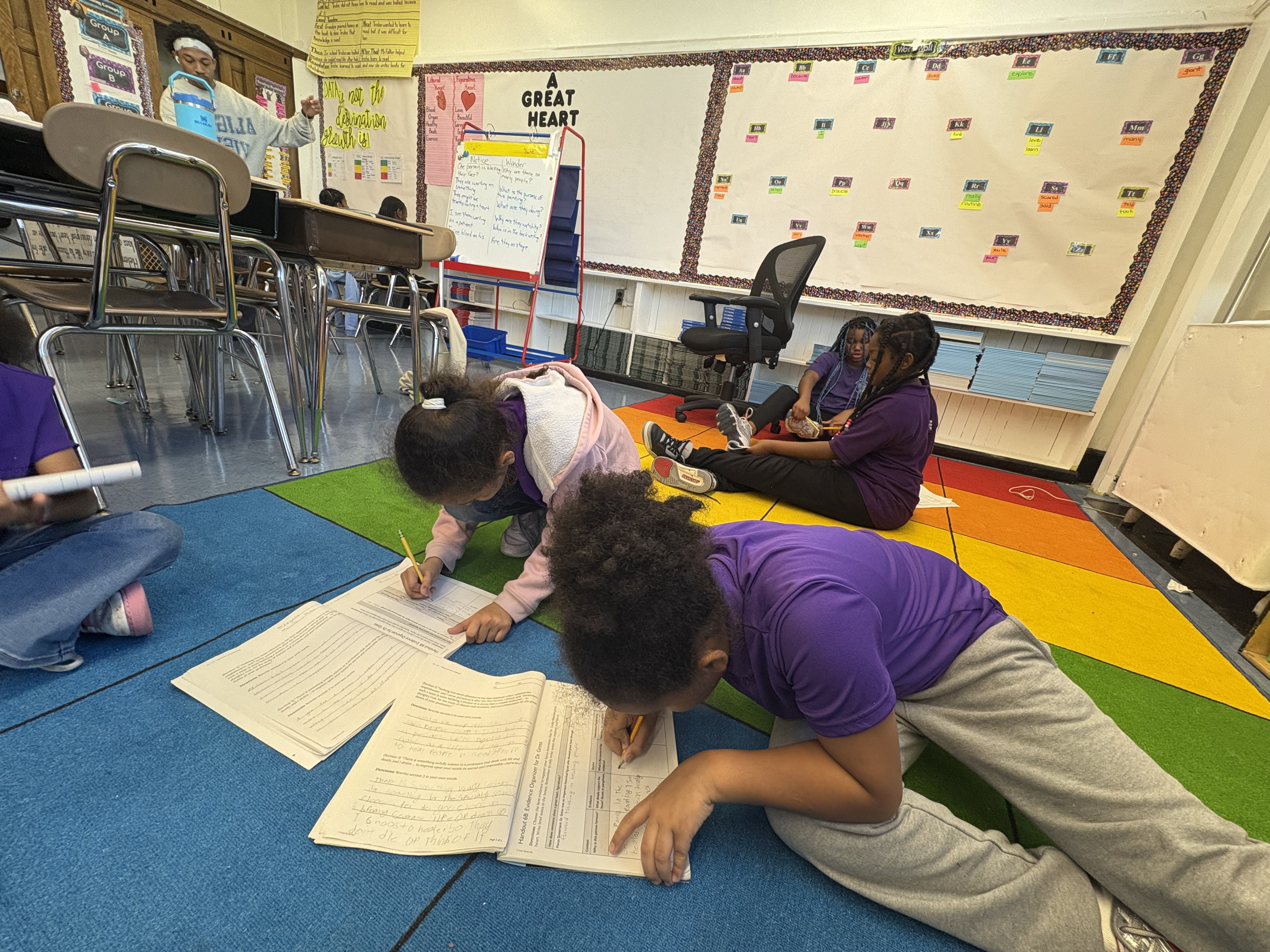 Five children standing on a polished gym floor 
