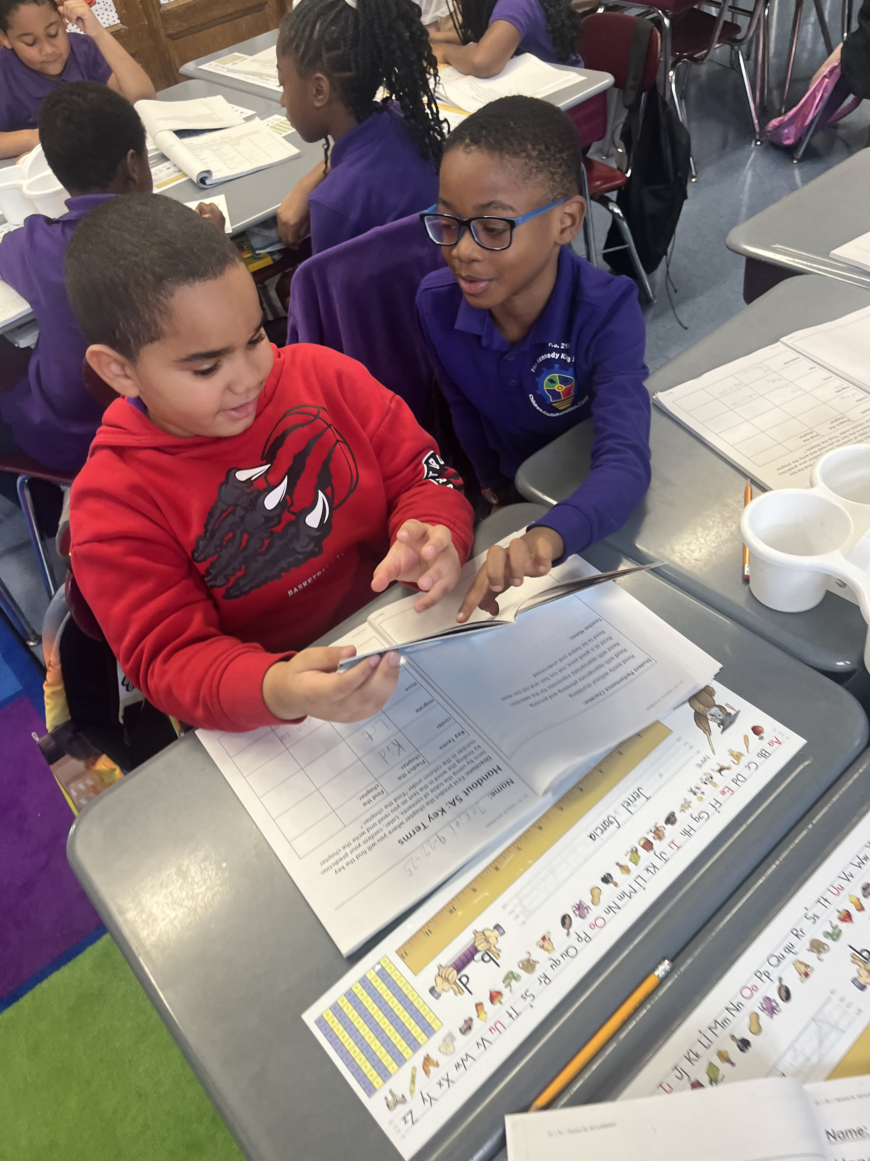 Five children standing on a polished gym floor 
