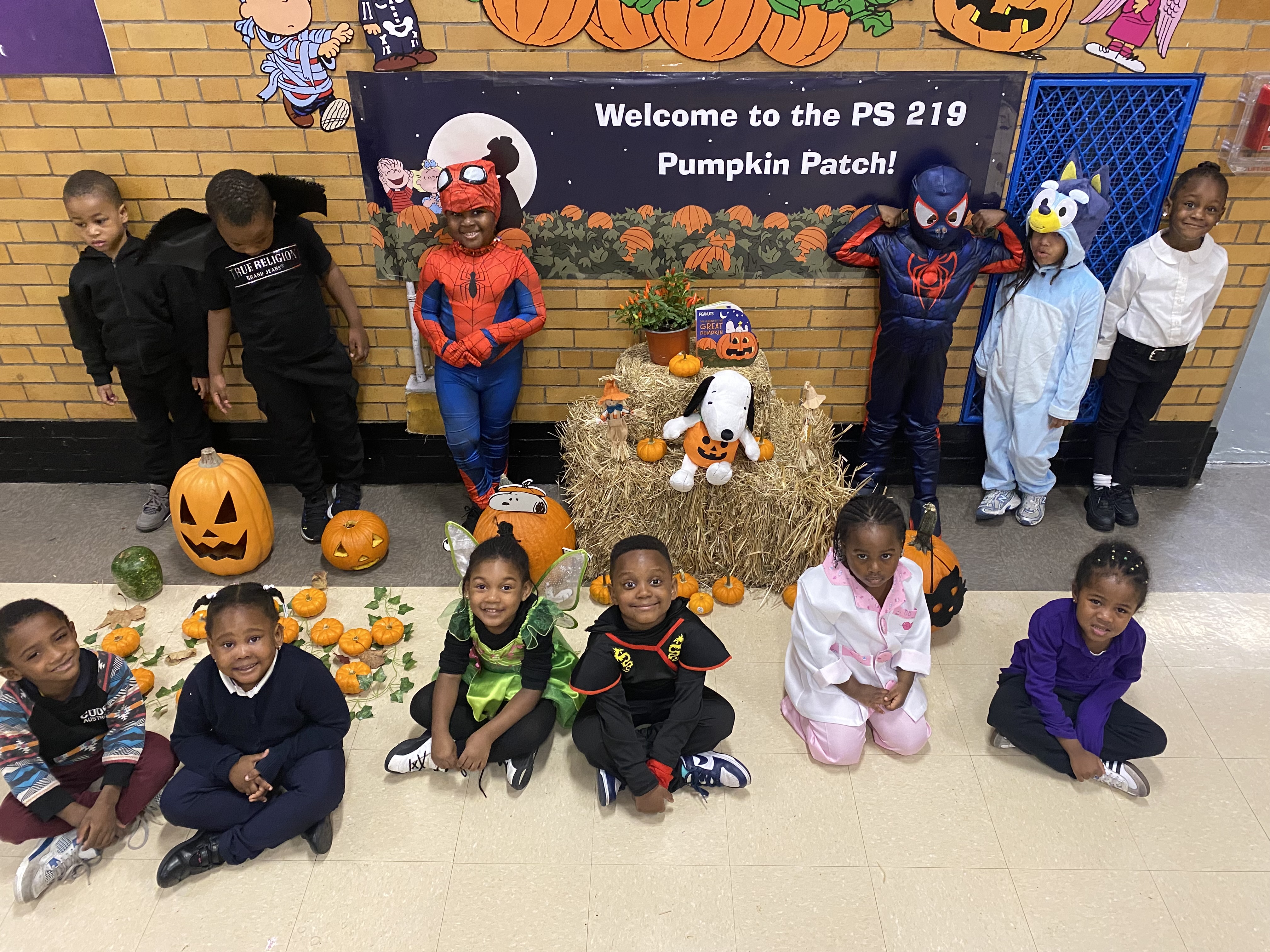 Five children standing on a polished gym floor 