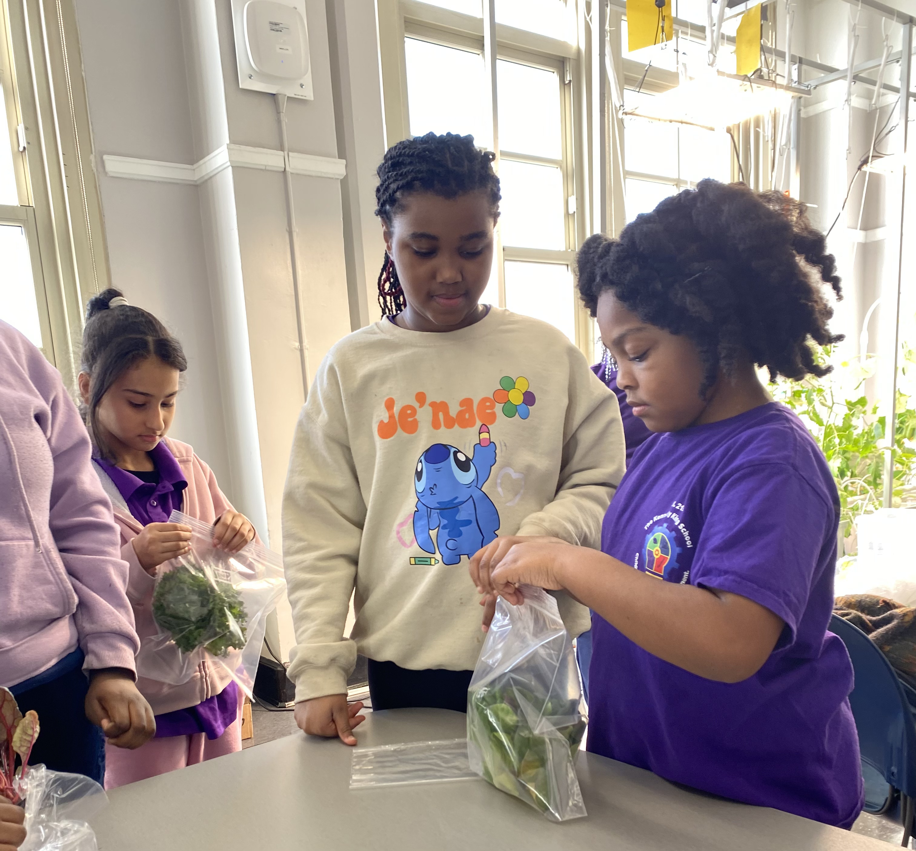 Preschool children sitting at red-covered