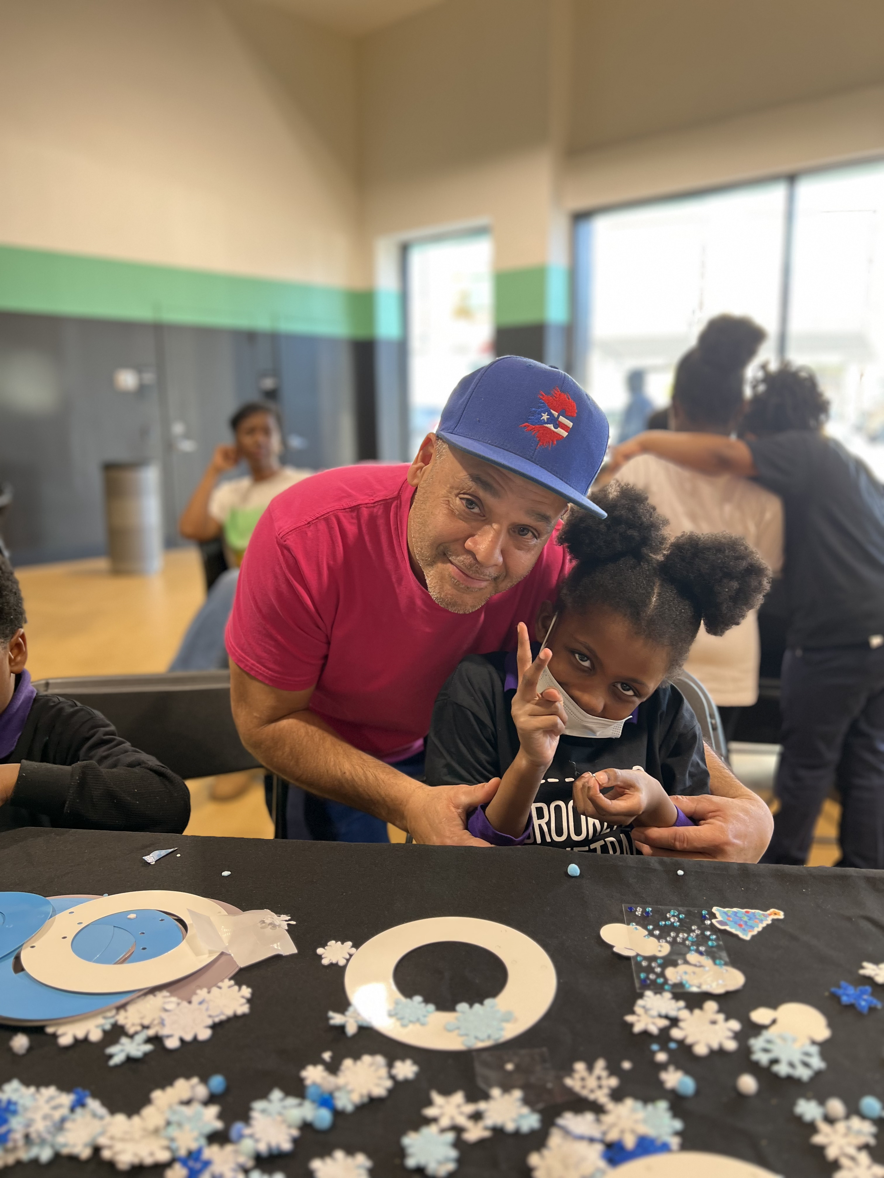 Five children standing on a polished gym floor 