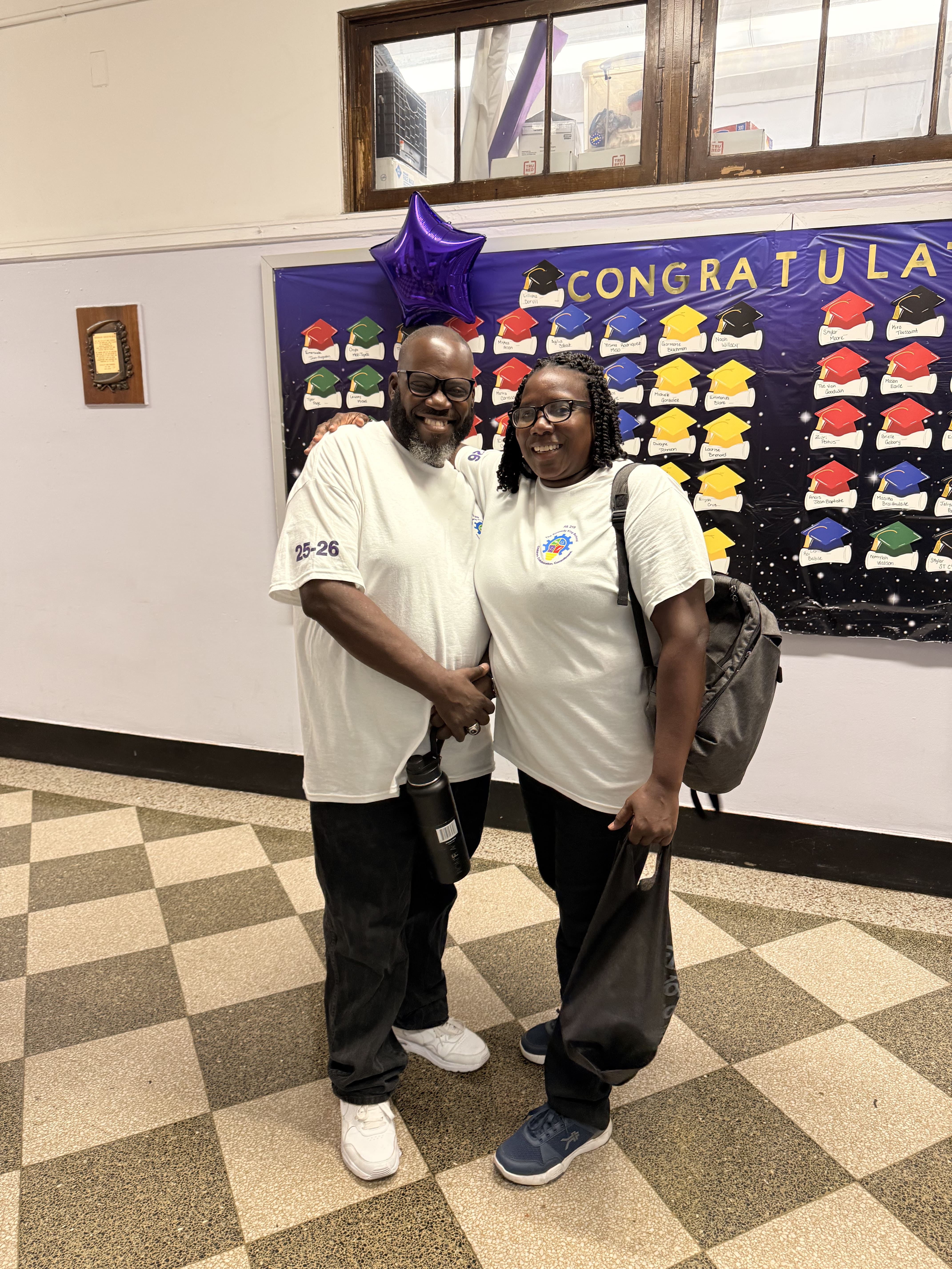Five children standing on a polished gym floor 