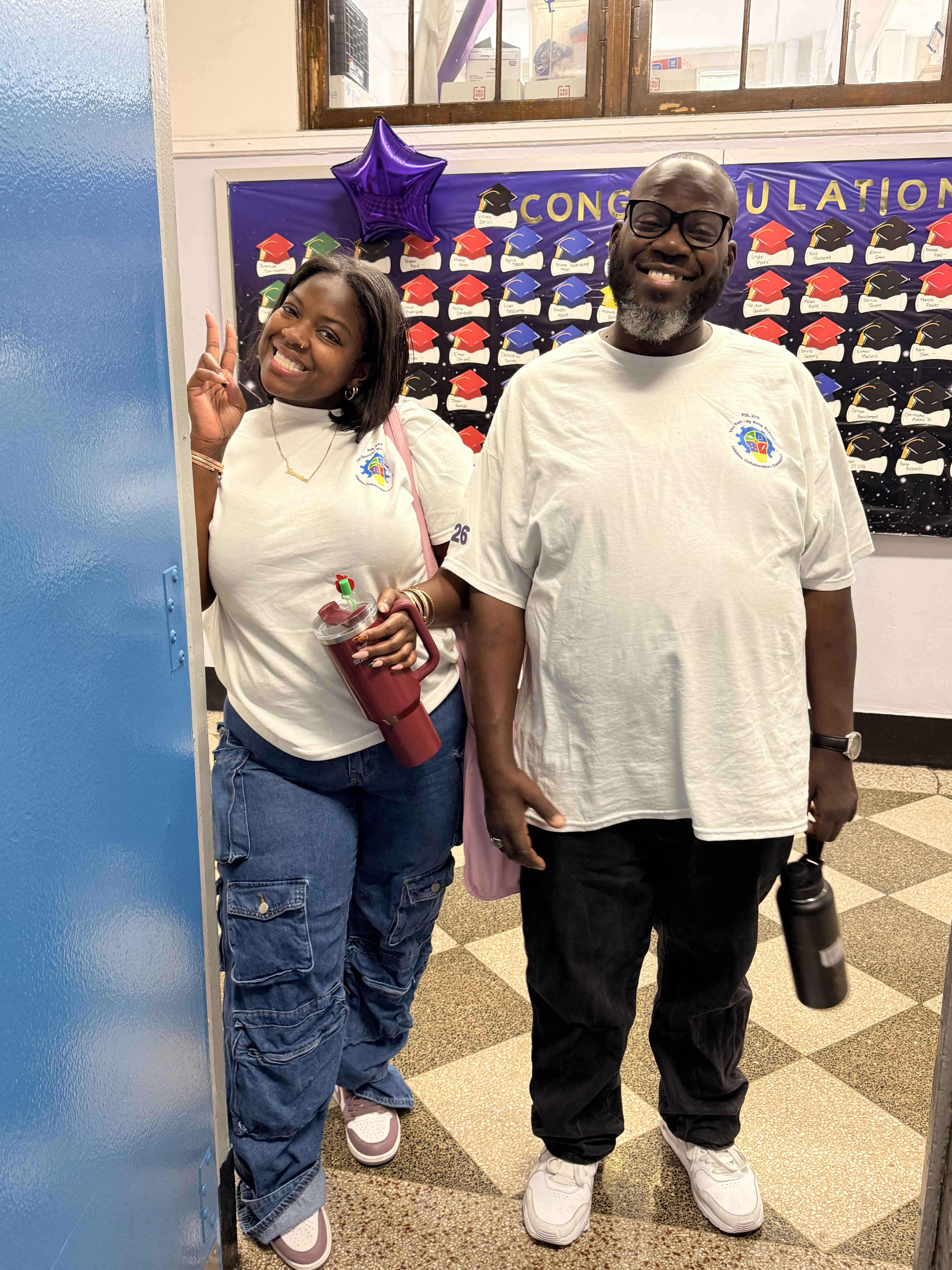 Five children standing on a polished gym floor 