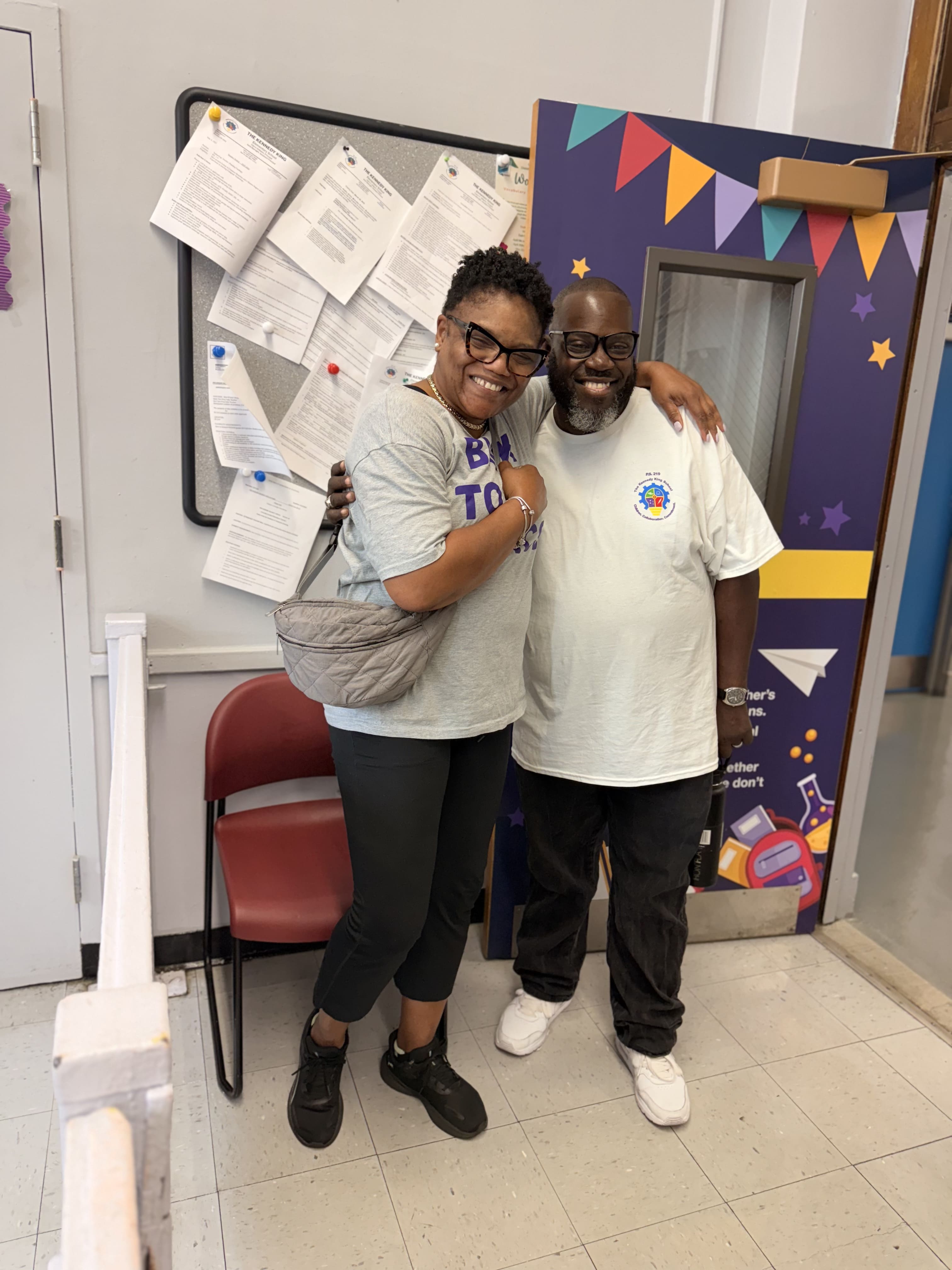 Five children standing on a polished gym floor 