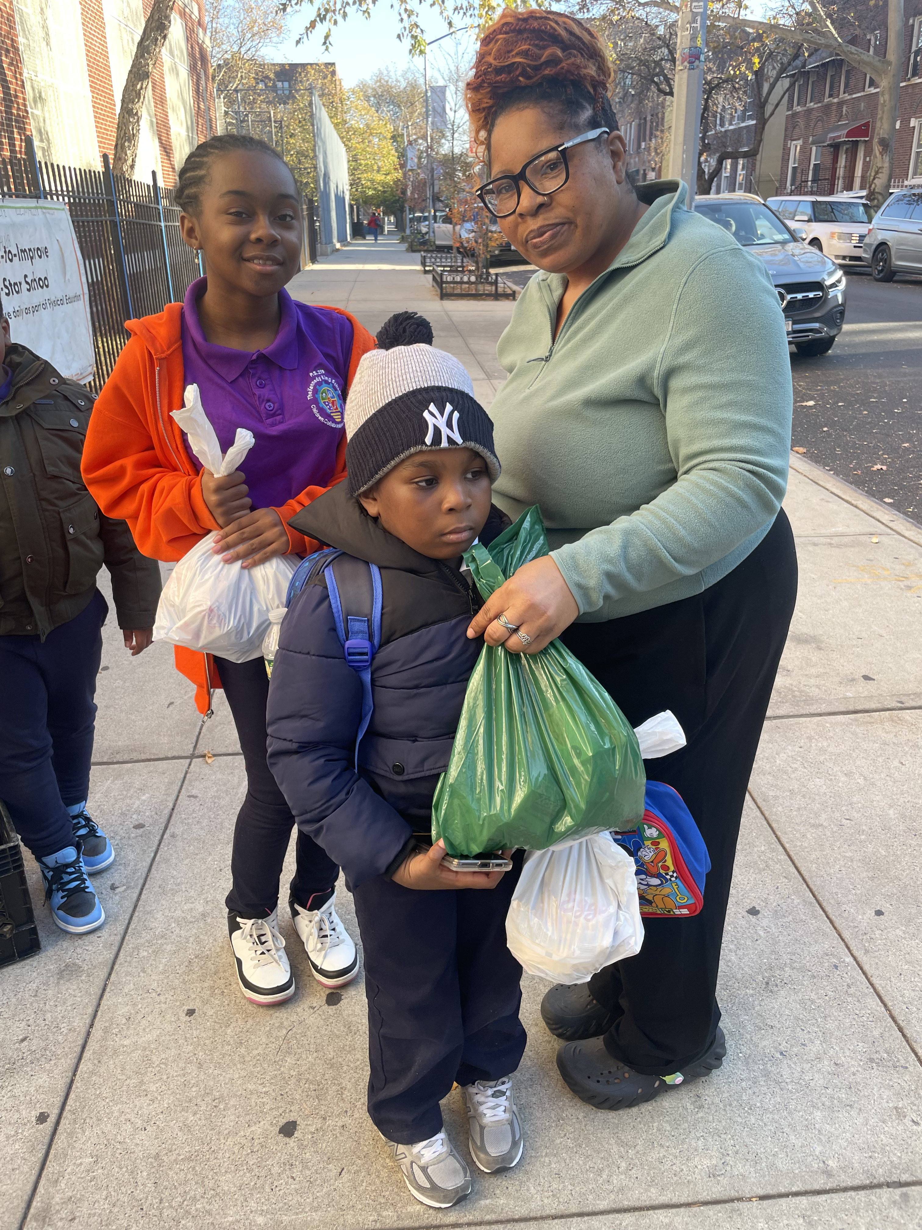 Five children standing on a polished gym floor 