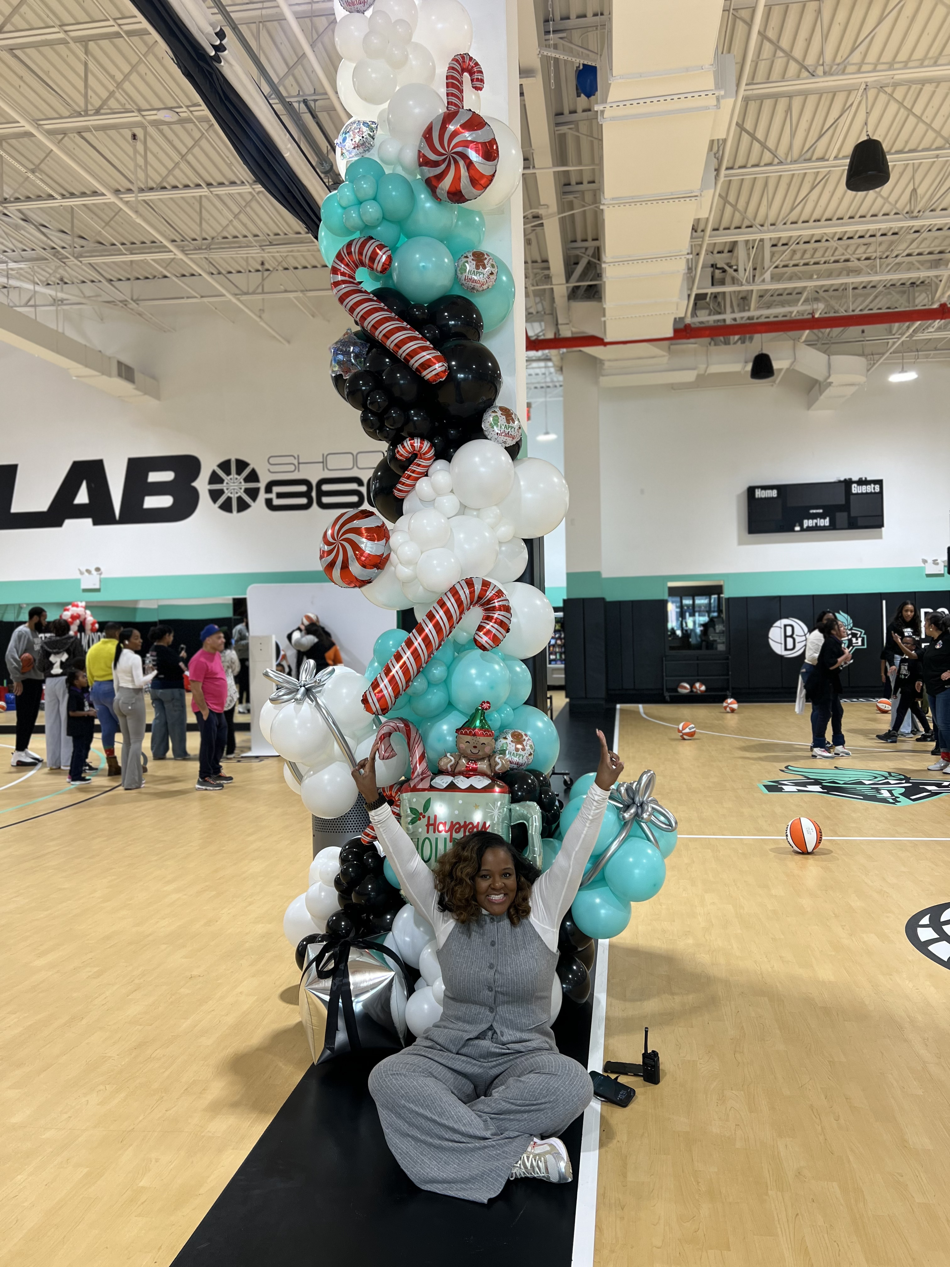 Five children standing on a polished gym floor 