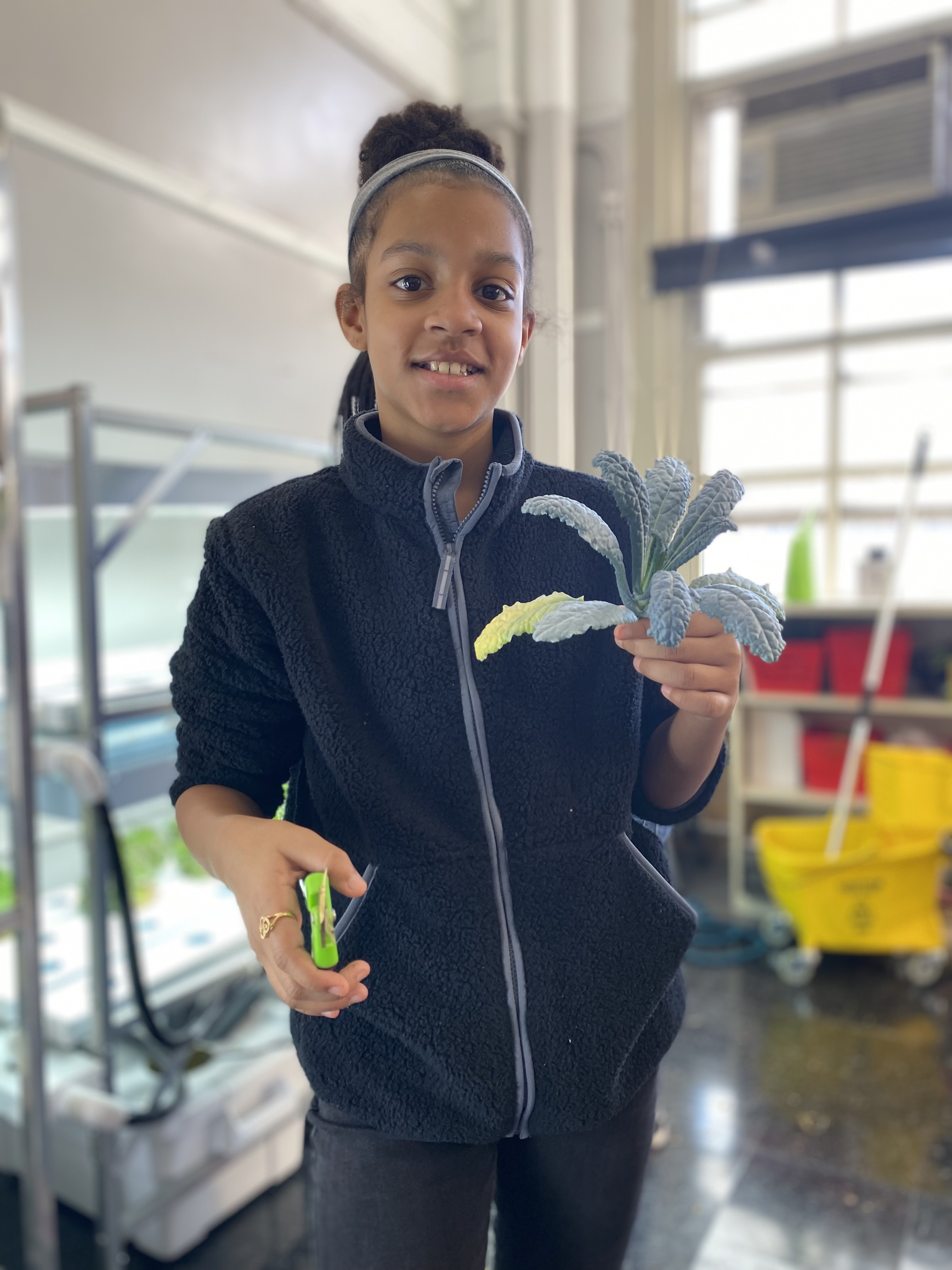 Five children standing on a polished gym floor 