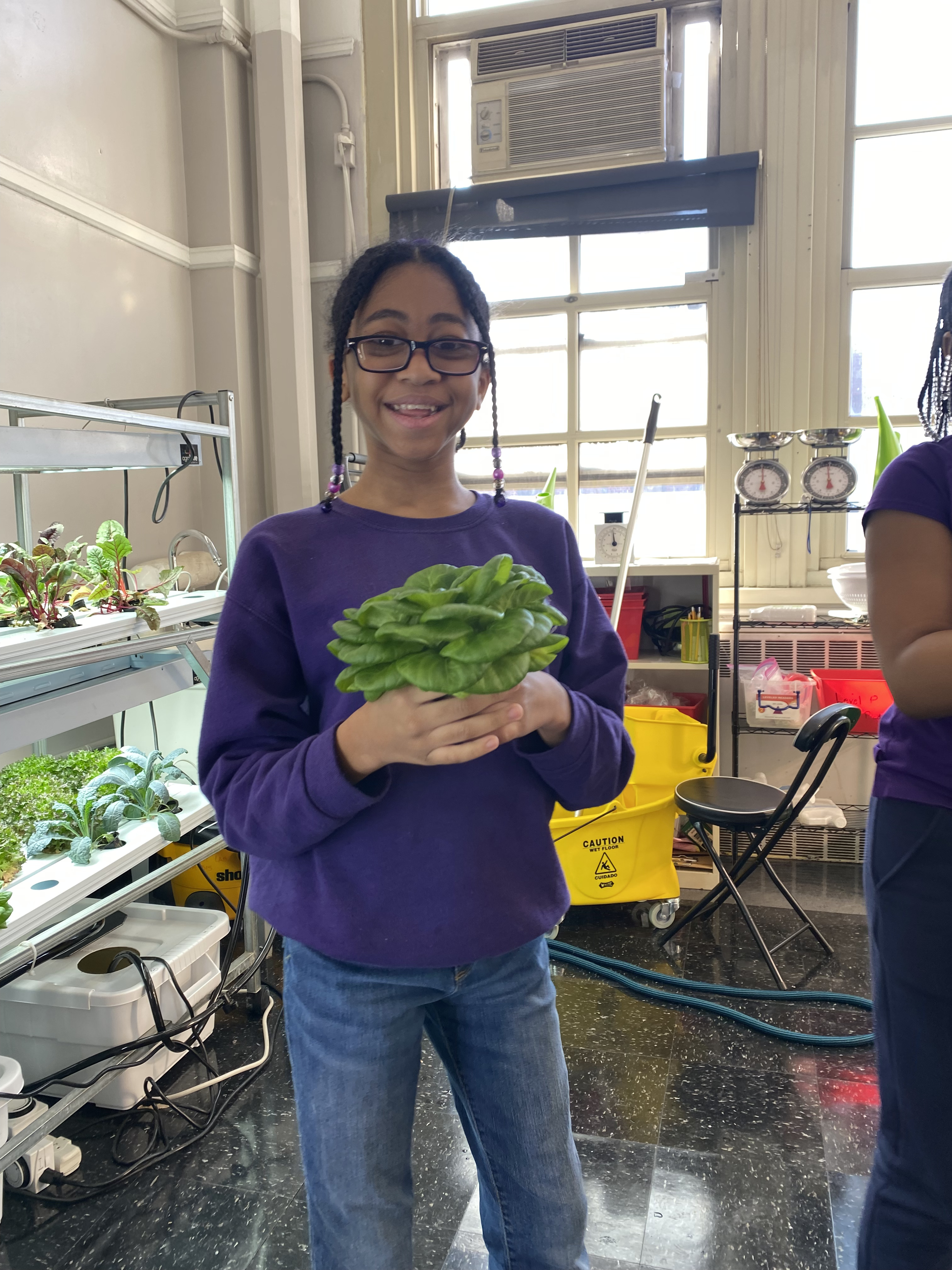 Five children standing on a polished gym floor 