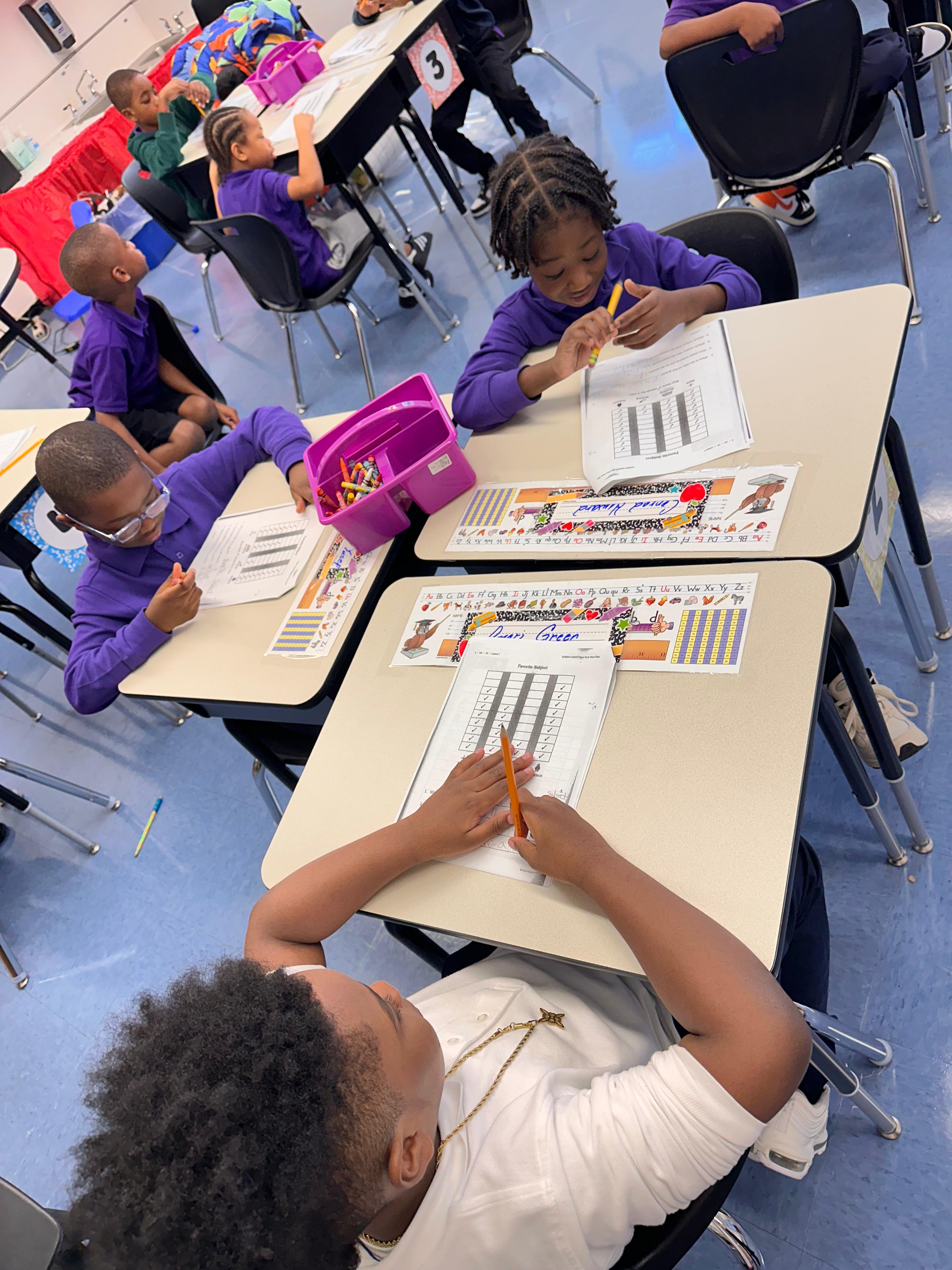 Five children standing on a polished gym floor 